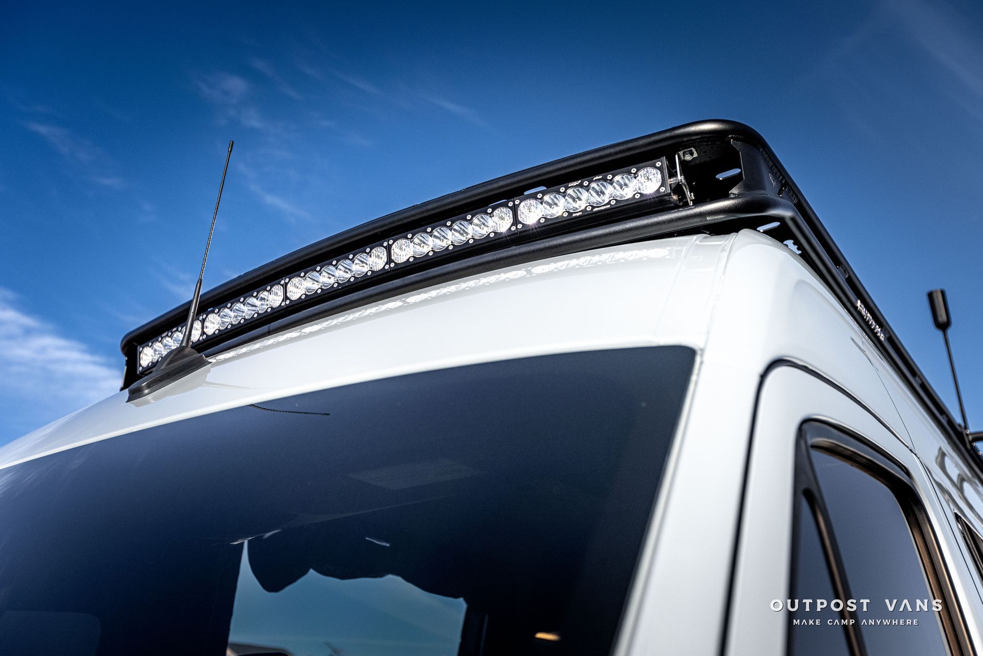 a white van with a light bar on top of it .