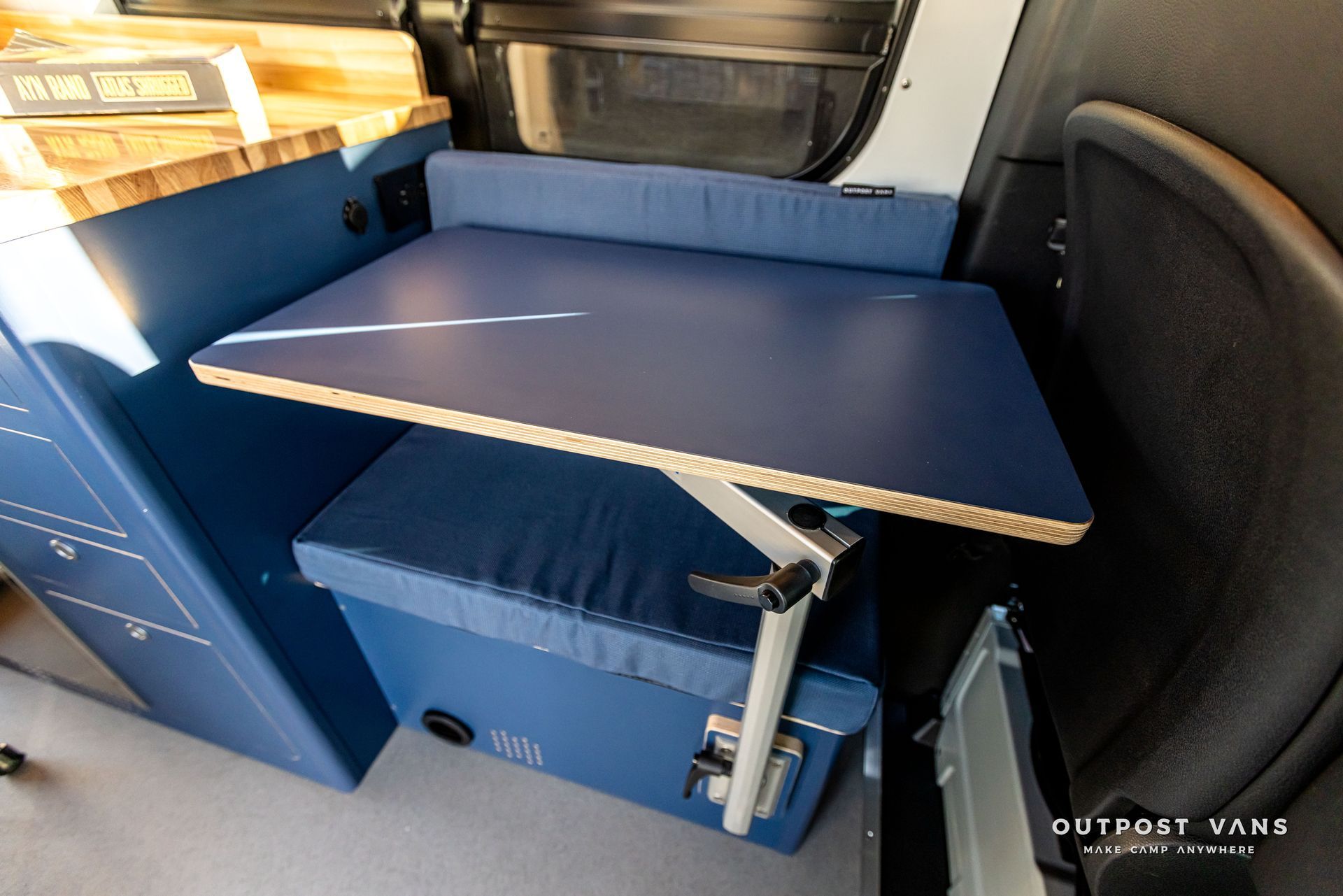 A blue table is sitting in the back of a van.