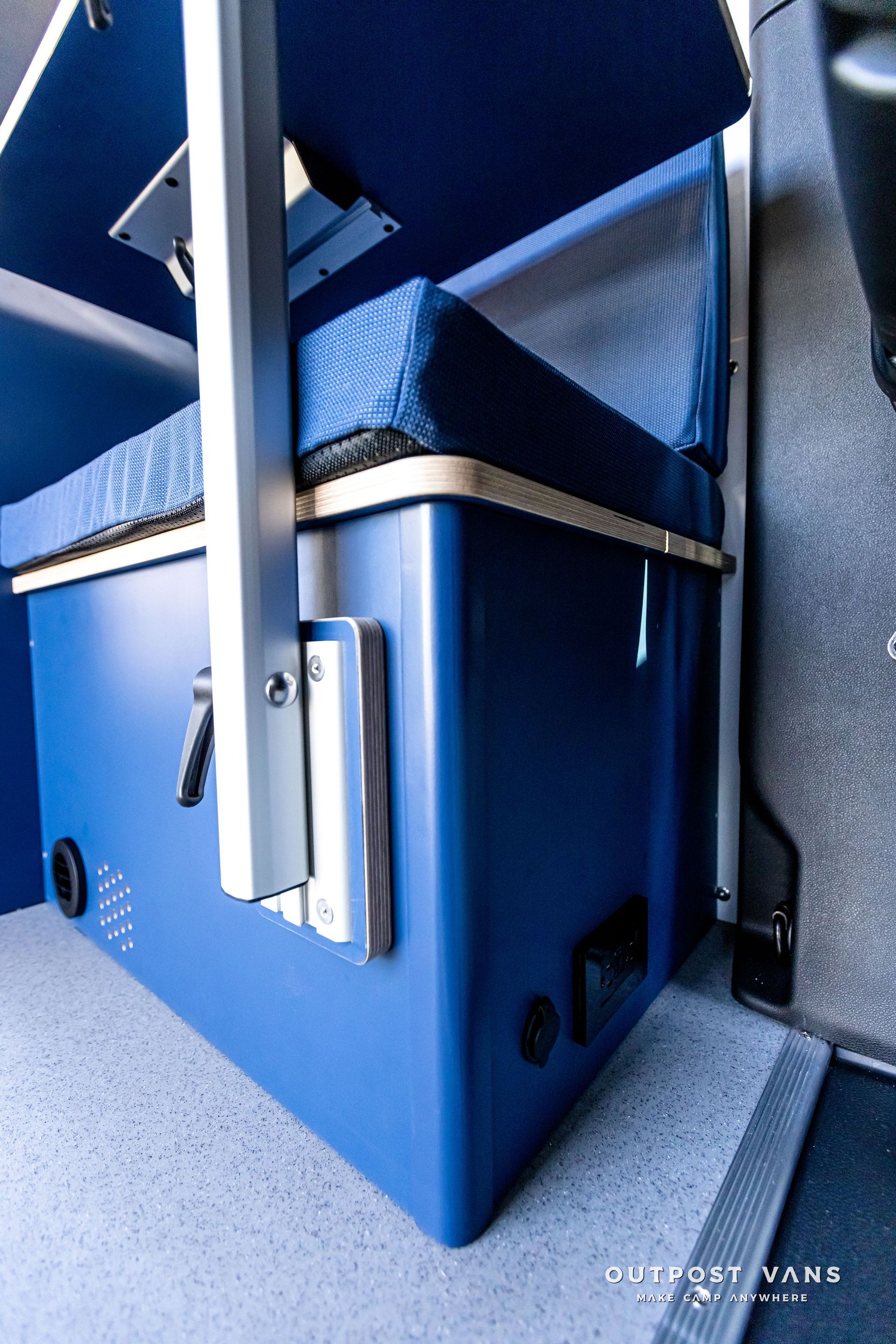 A blue cooler with a handle on the side of it