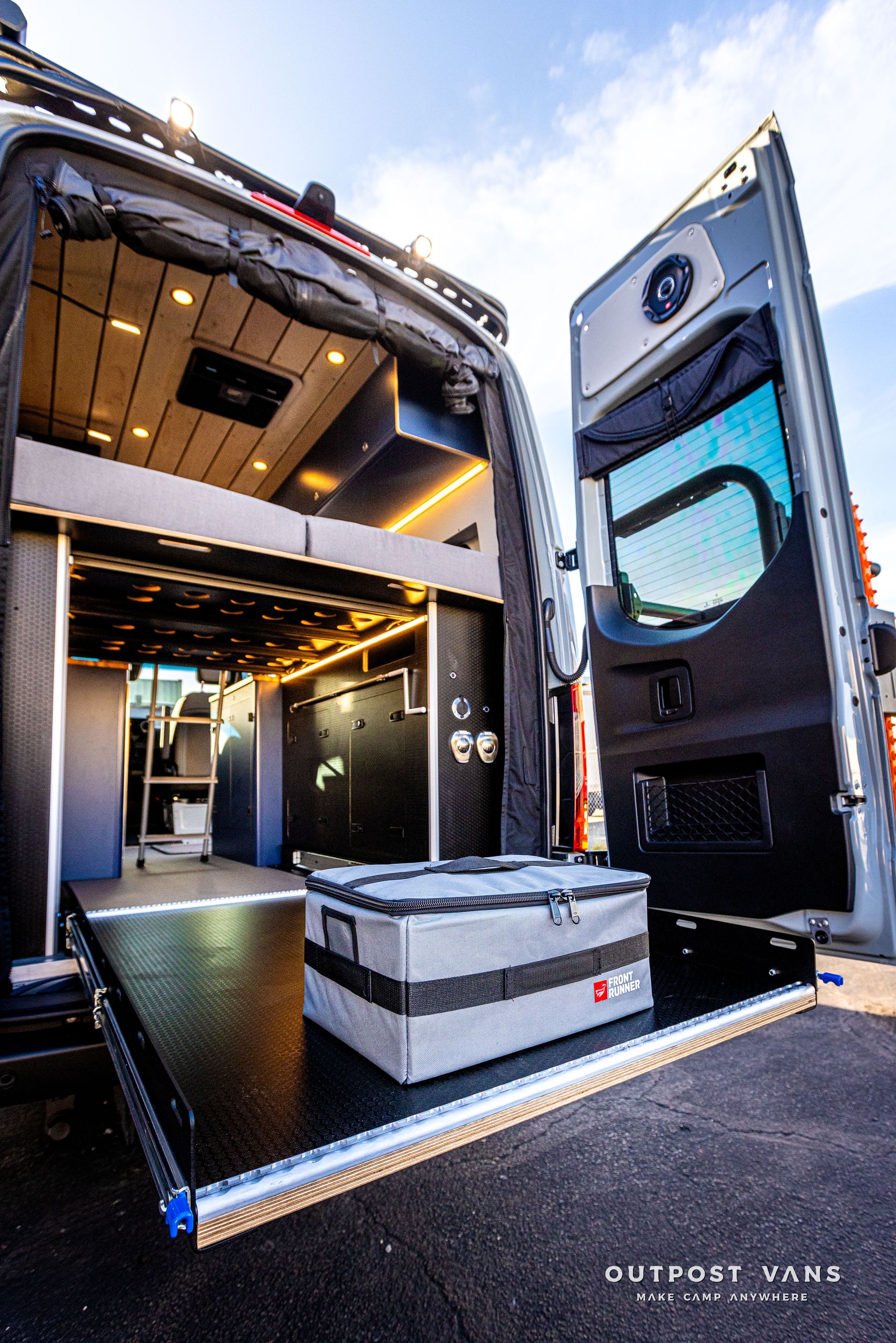 The back of a van with the door open and a box in the back.