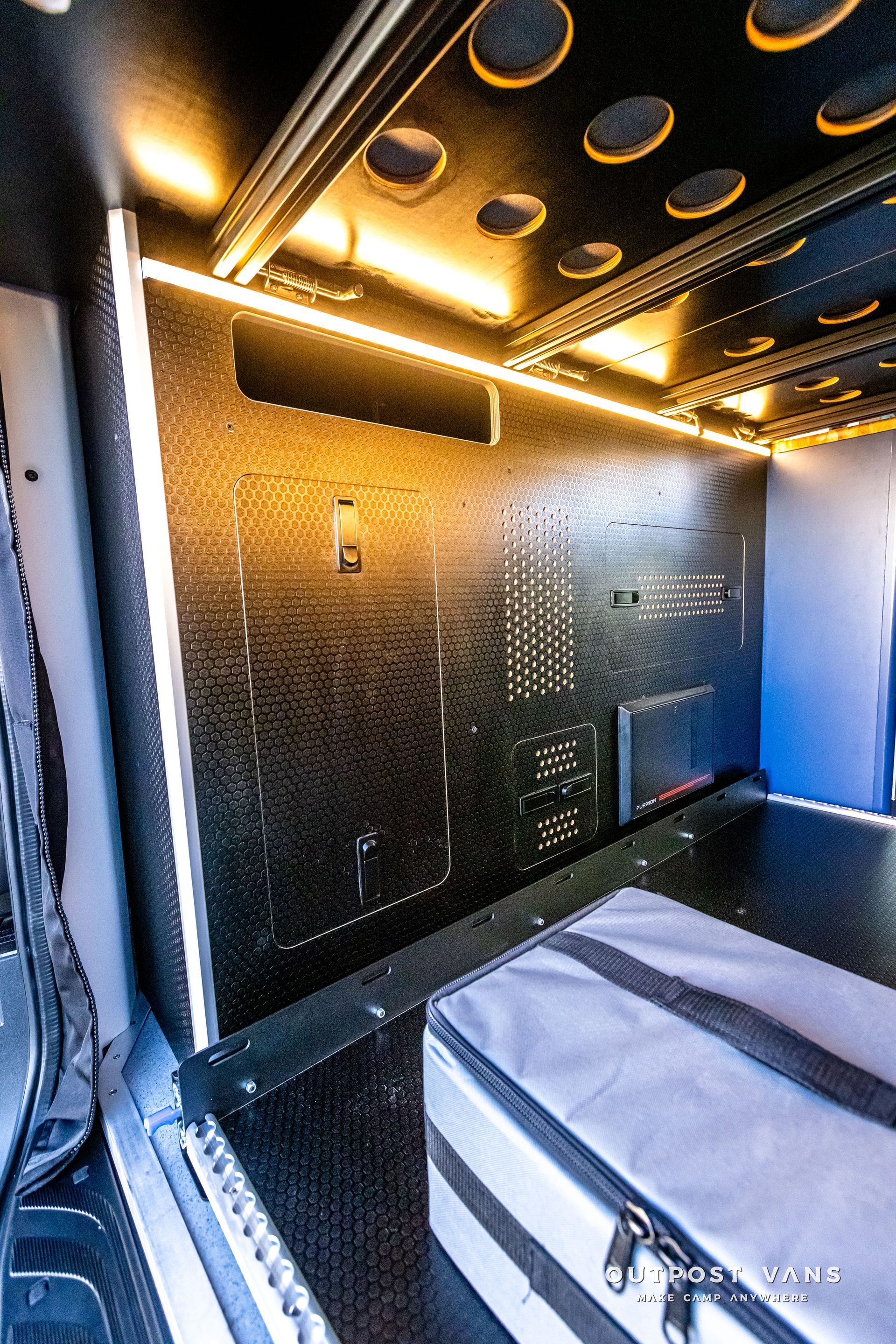 A room with a lot of lights on the ceiling and a bag on the floor.