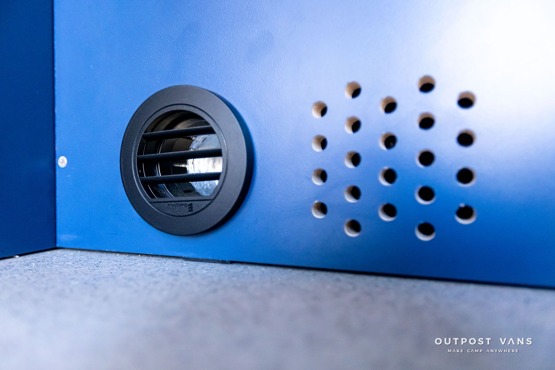 A close up of a blue wall with holes in it