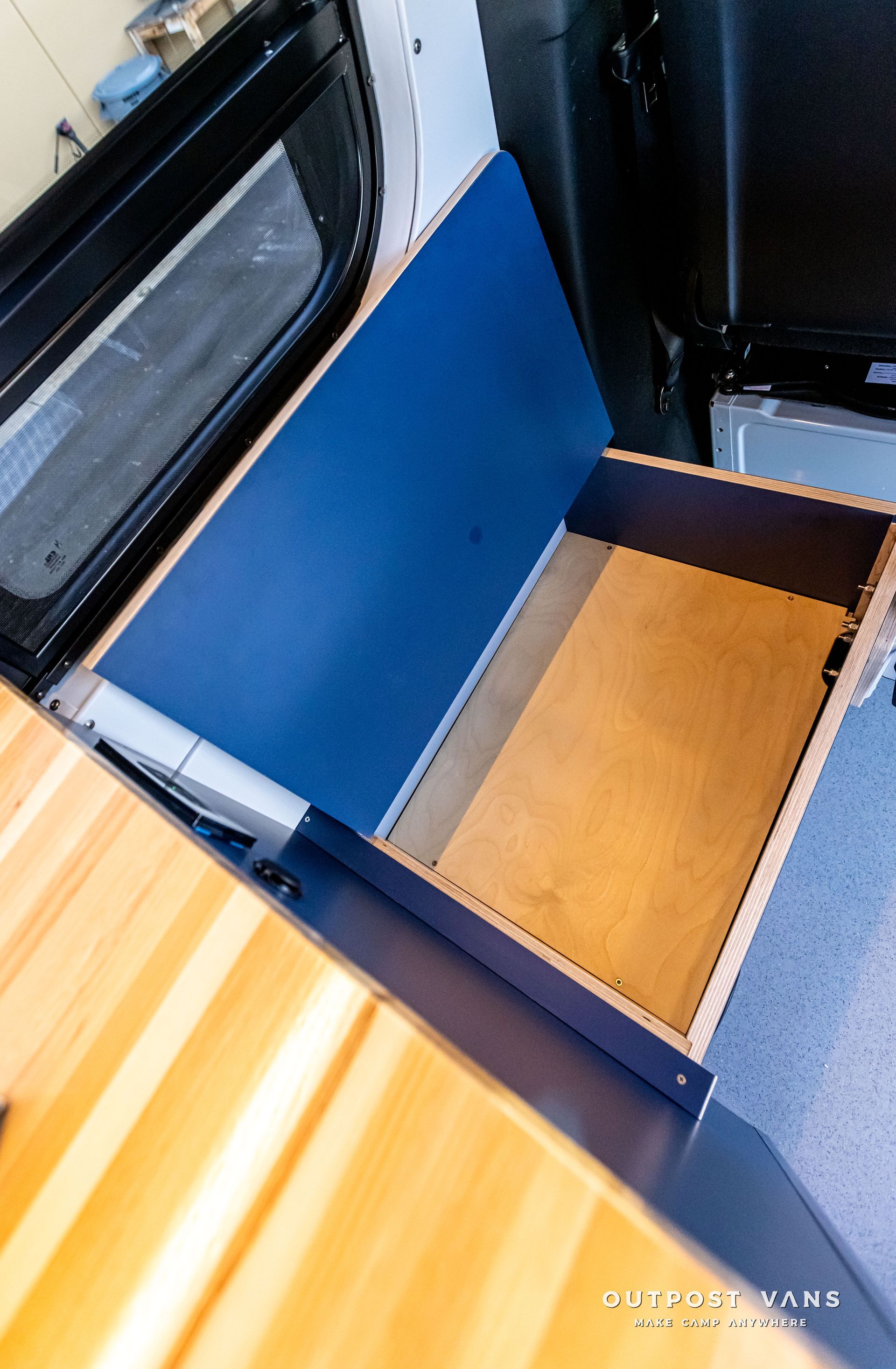 A wooden drawer is open in a van