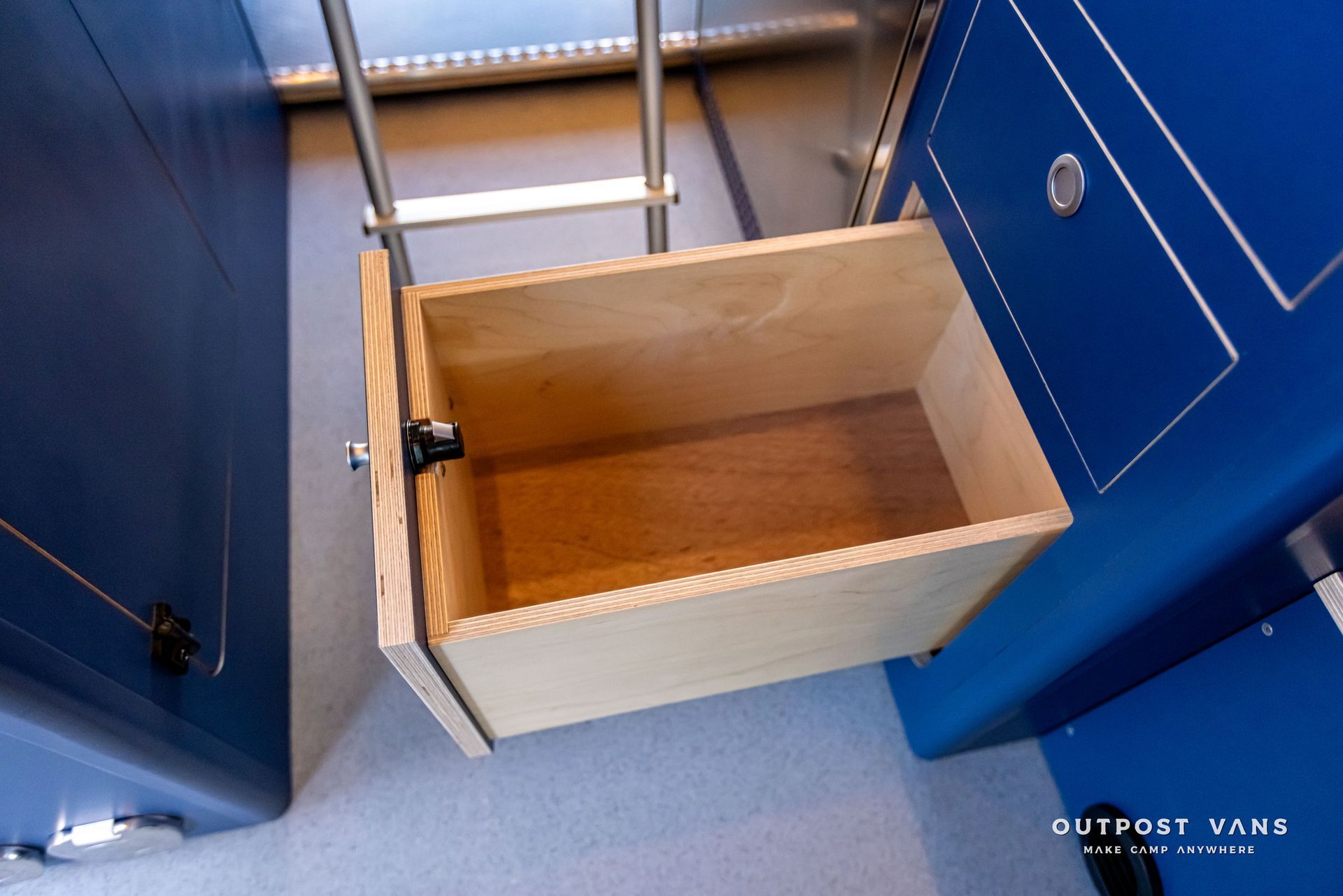 A wooden drawer with the word outpost tank on the bottom