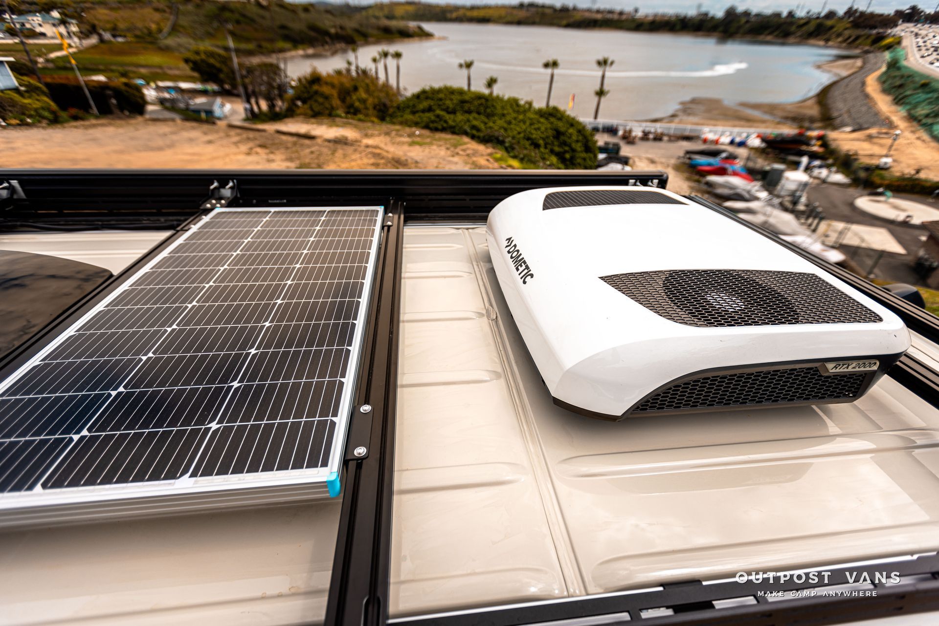 A van with solar panels and air conditioning on the roof.