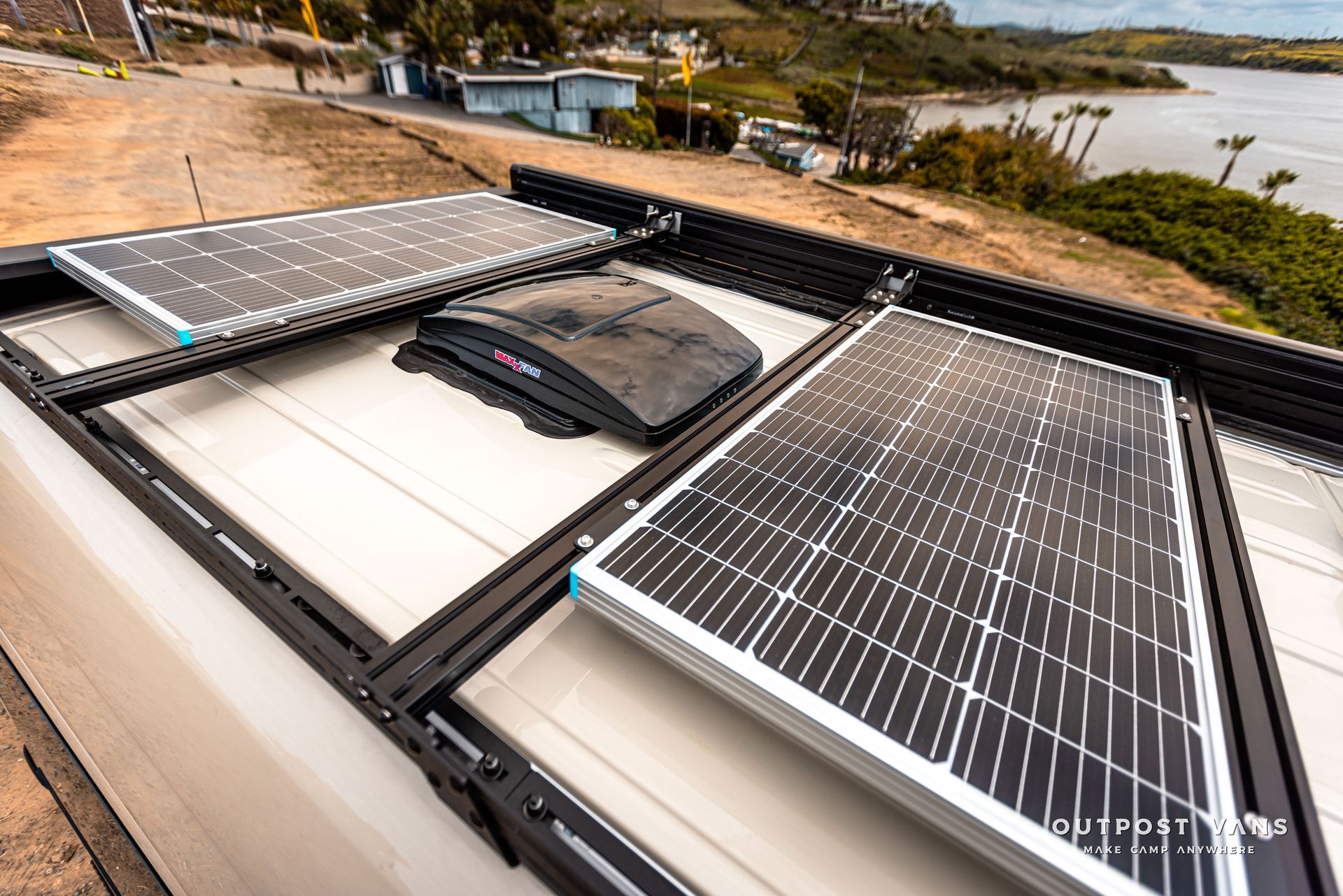 A bunch of solar panels are sitting on top of a van.