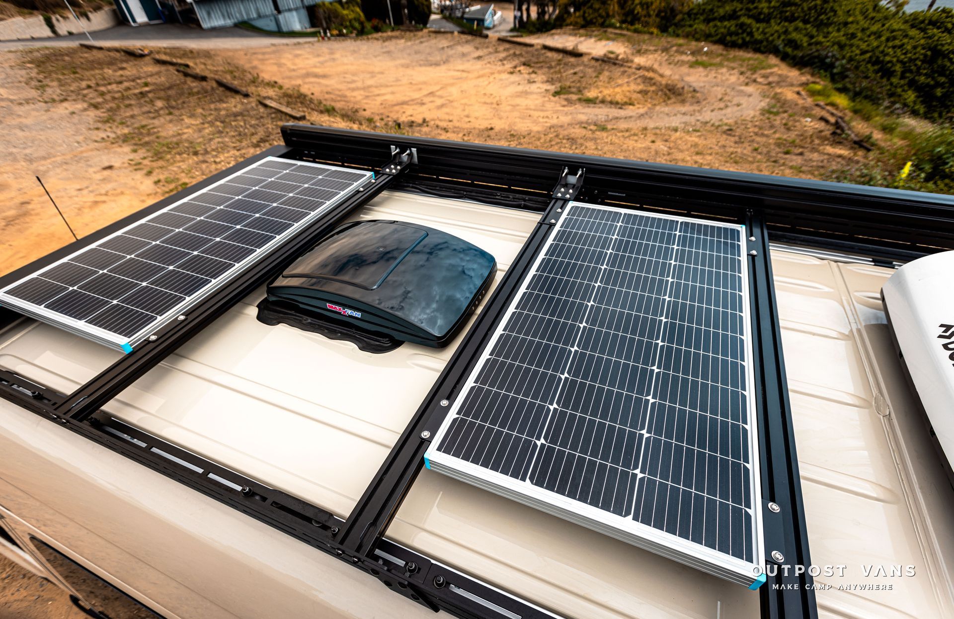 There are three solar panels on the roof of a vehicle.