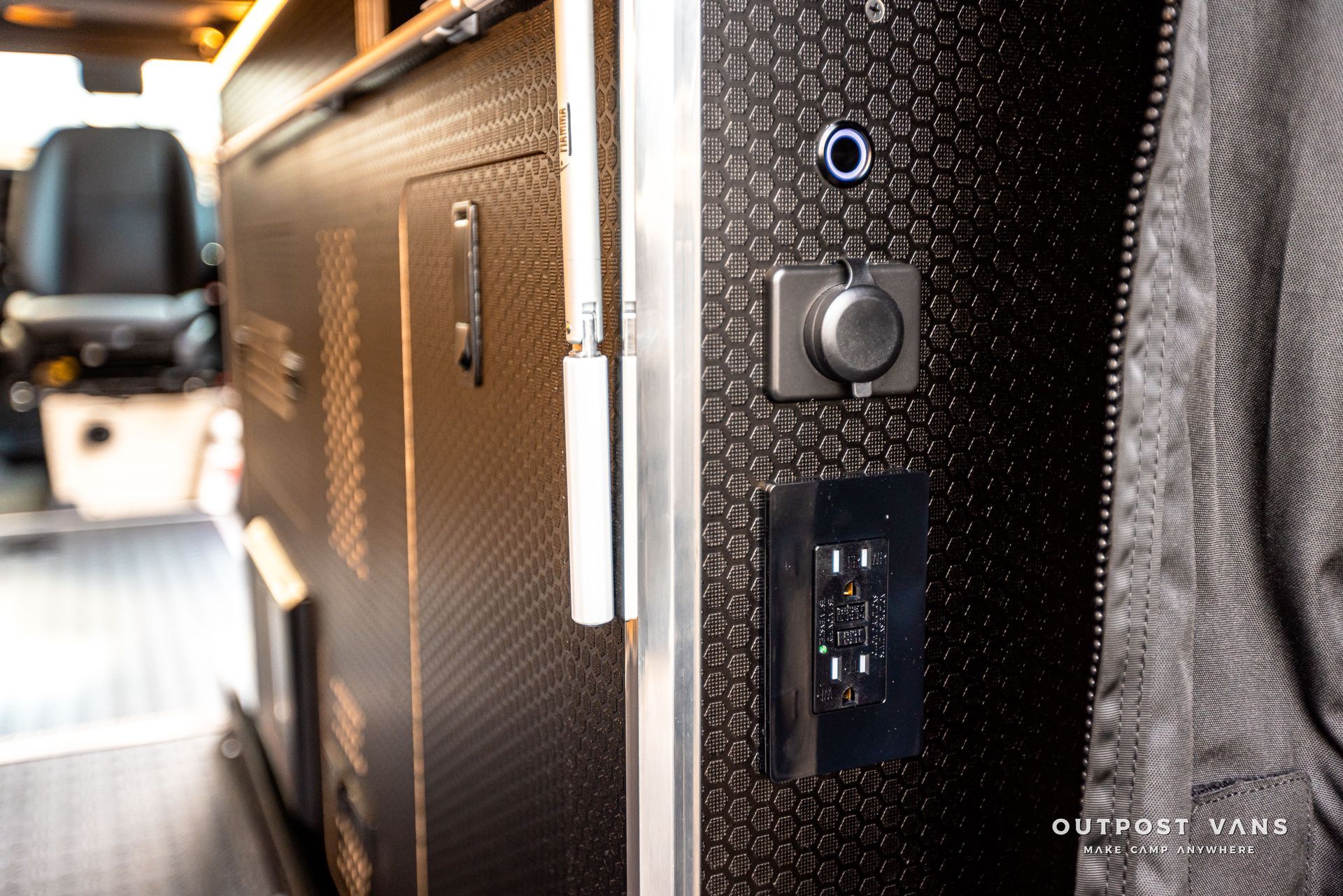 A close up of a electrical outlet on the side of a van