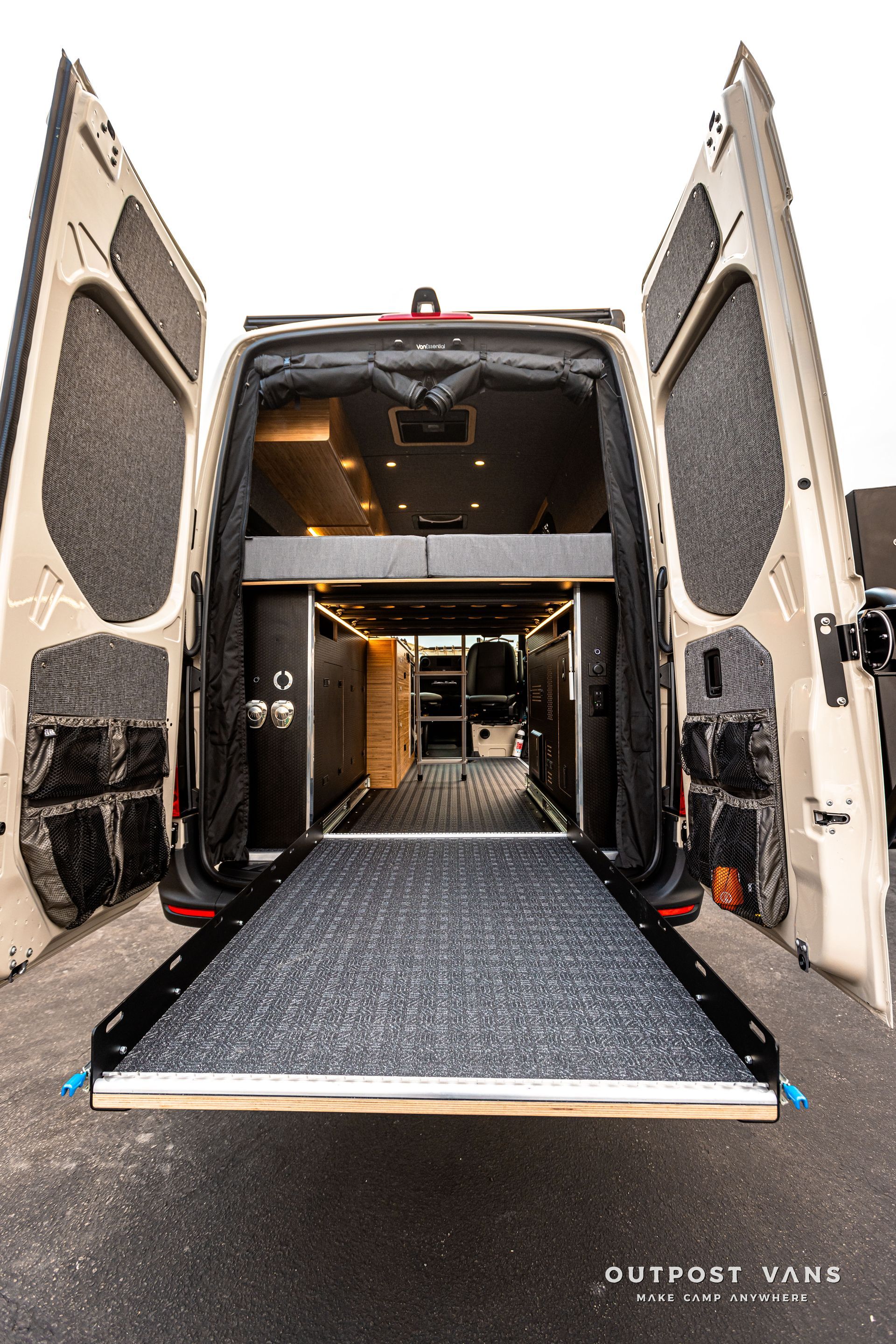 The back of a van with its doors open and a ramp.