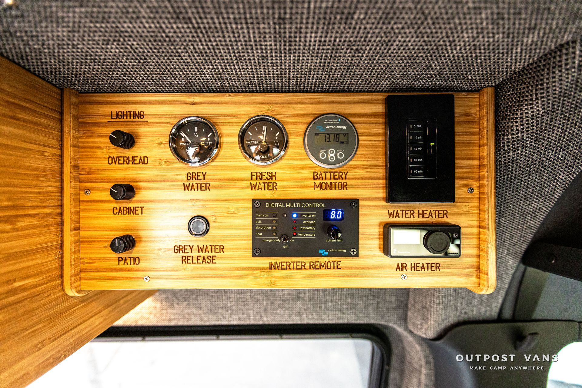 A wooden dashboard with a lot of buttons and switches on it.