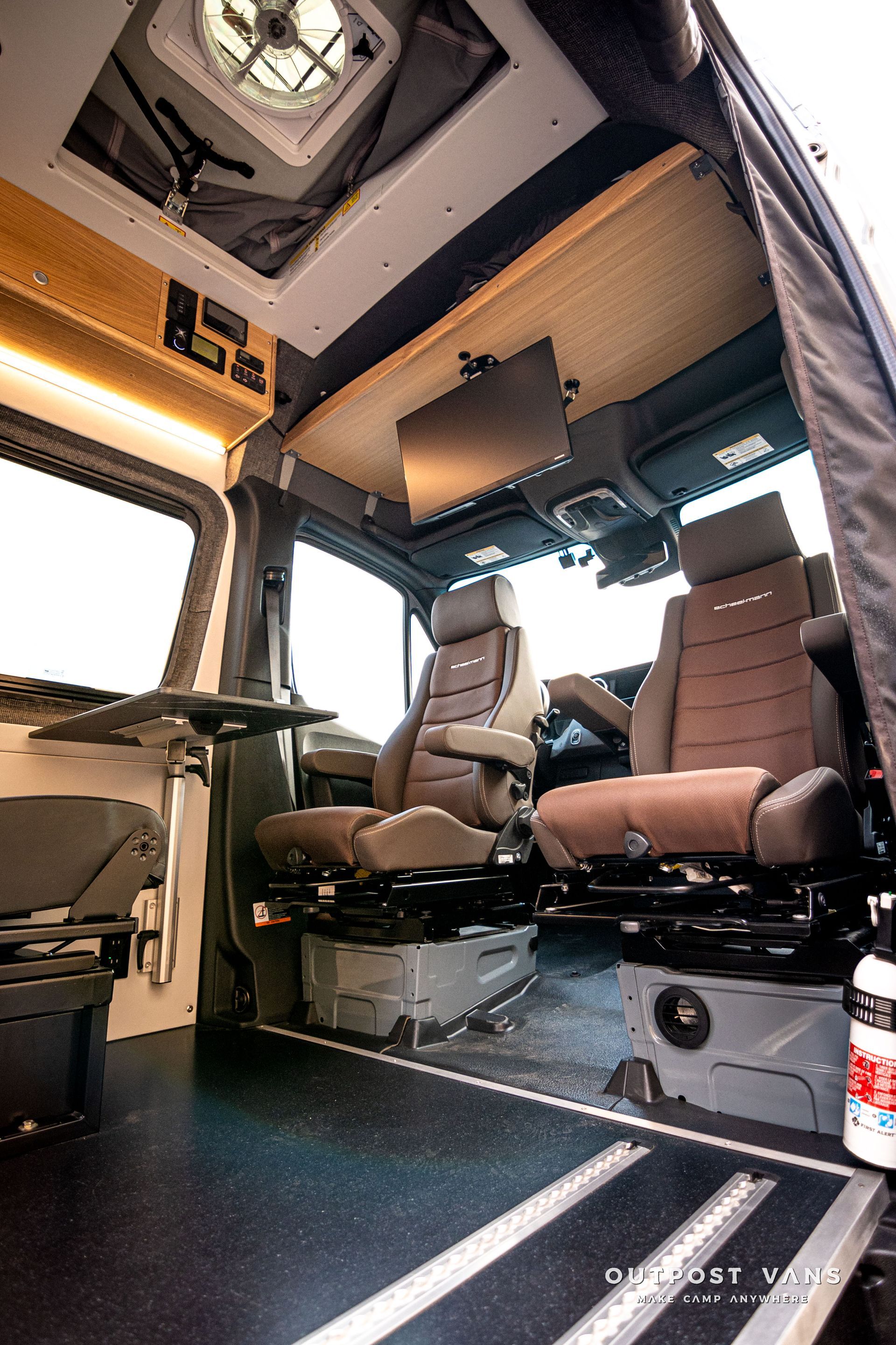 The inside of a van with a table and chairs.