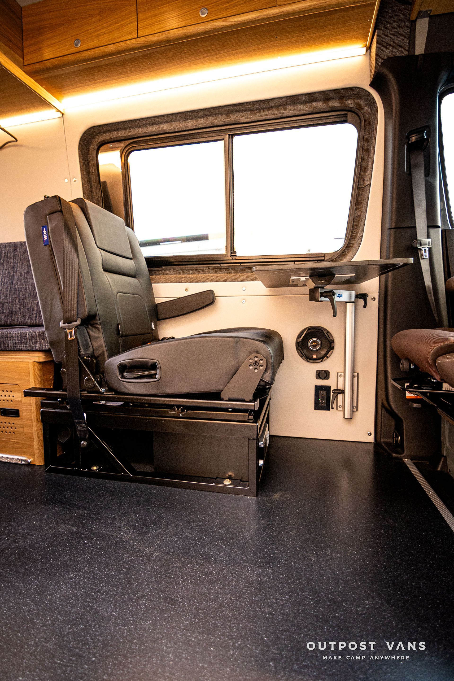 A van with a seat and a table in the back.