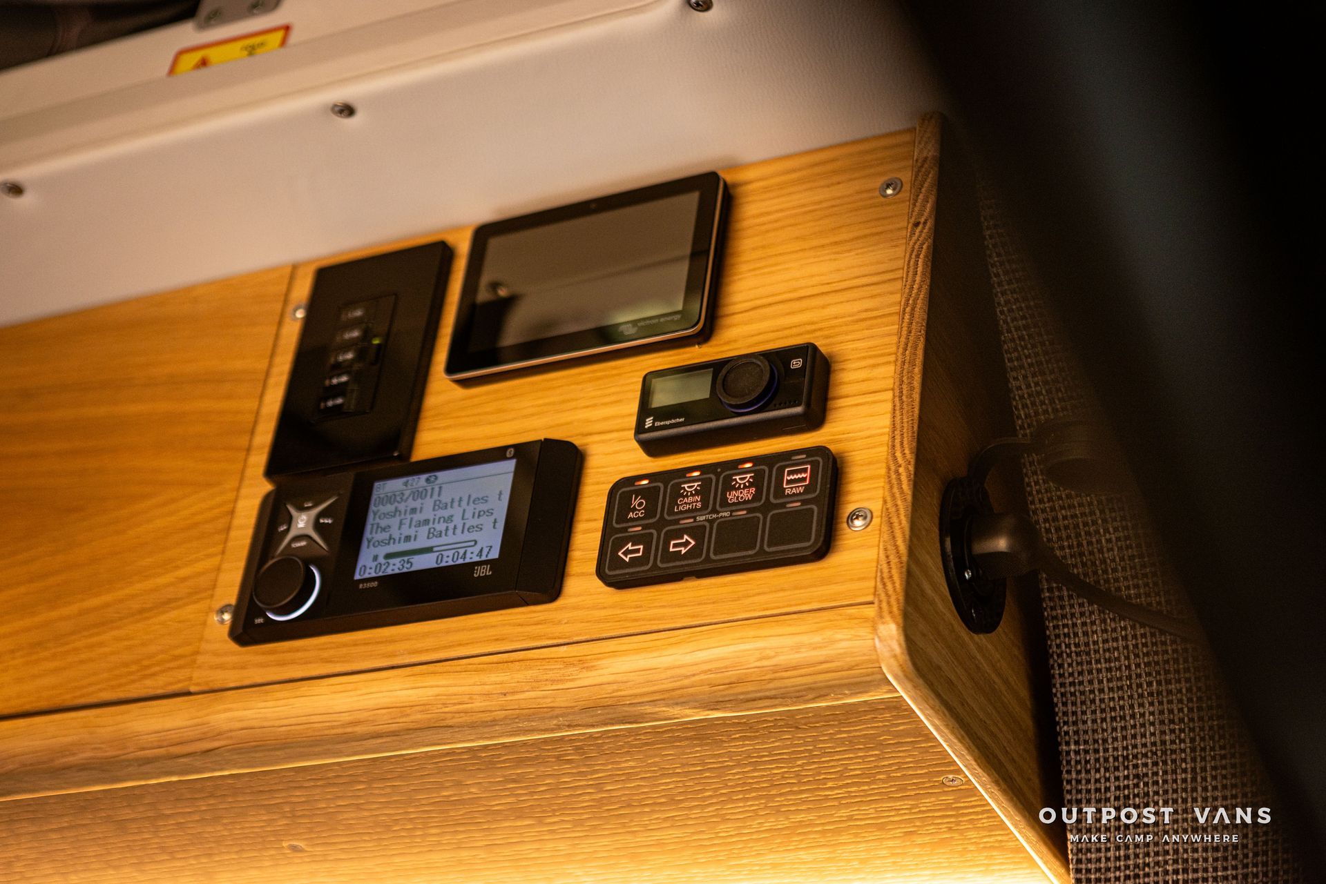 A wooden box with a bunch of electronics on it.