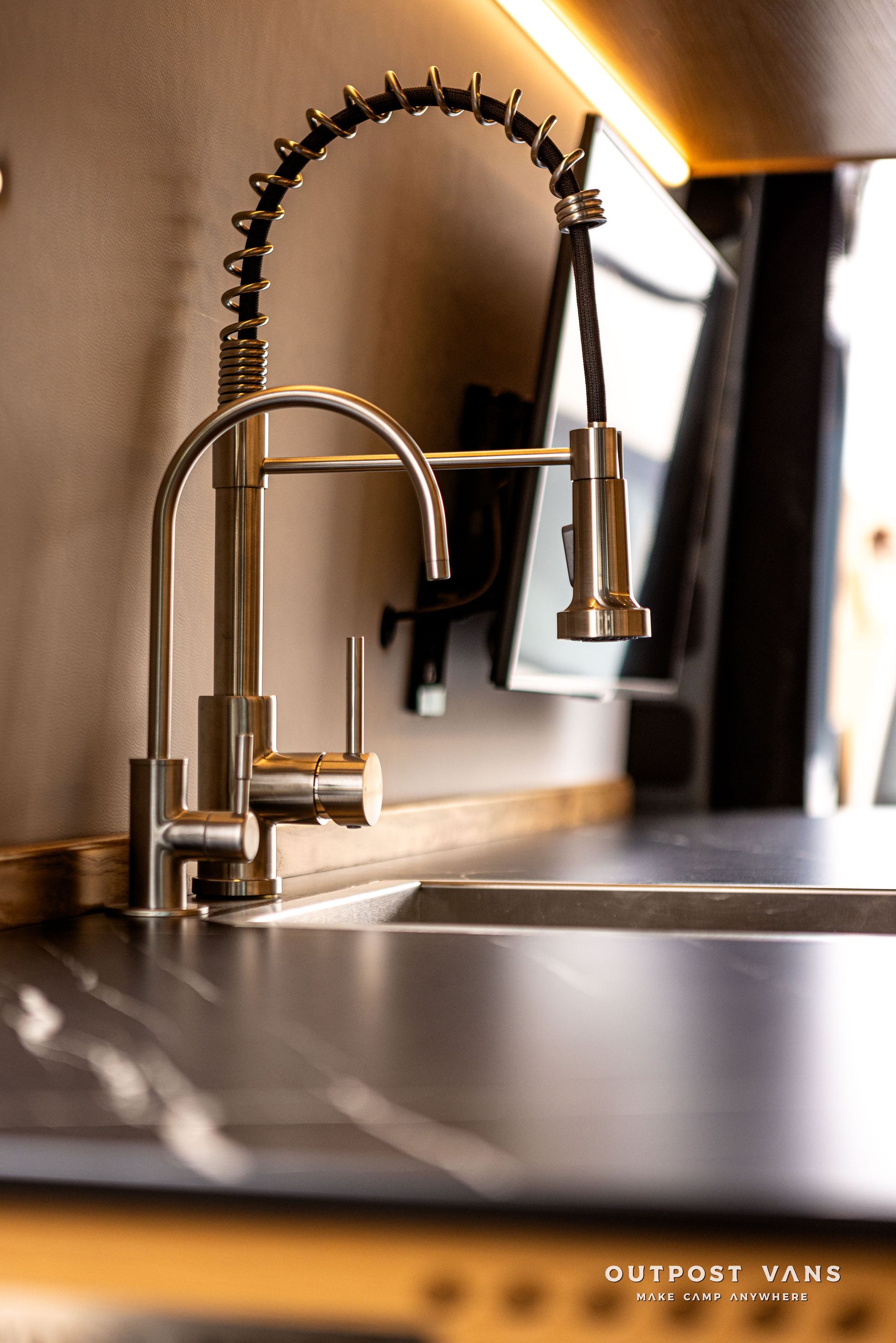 A close up of a kitchen sink with a faucet on it.