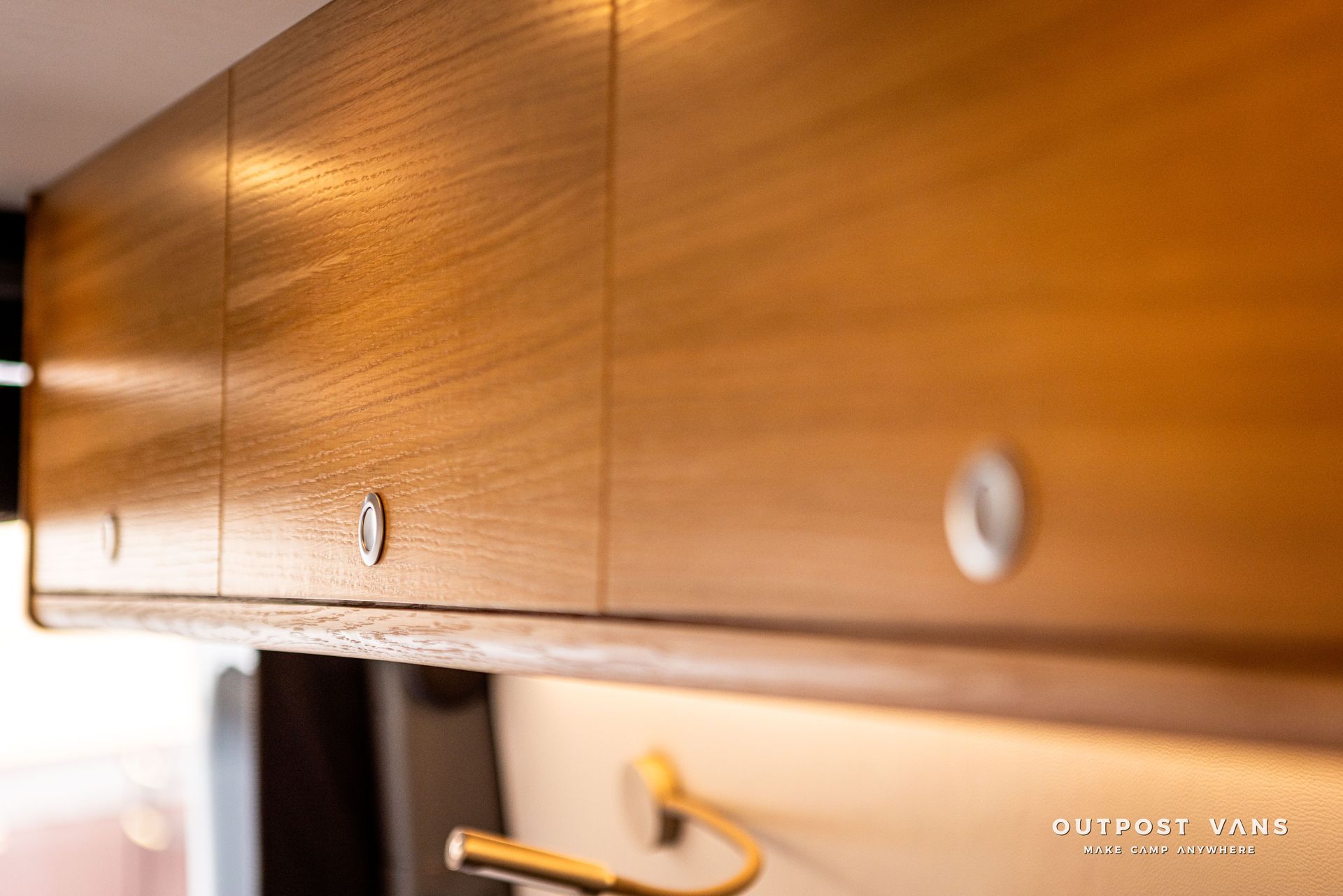 A kitchen with wooden cabinets and a sink.