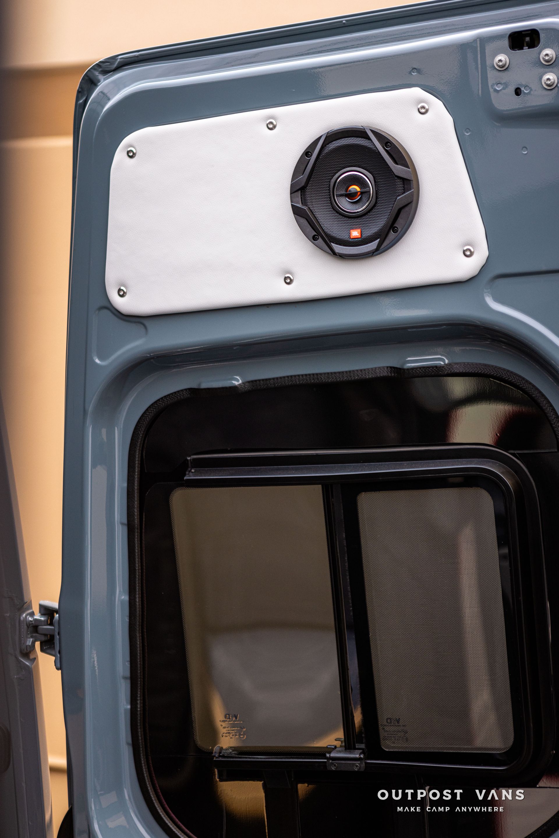 A close up of a speaker on the back of a van.