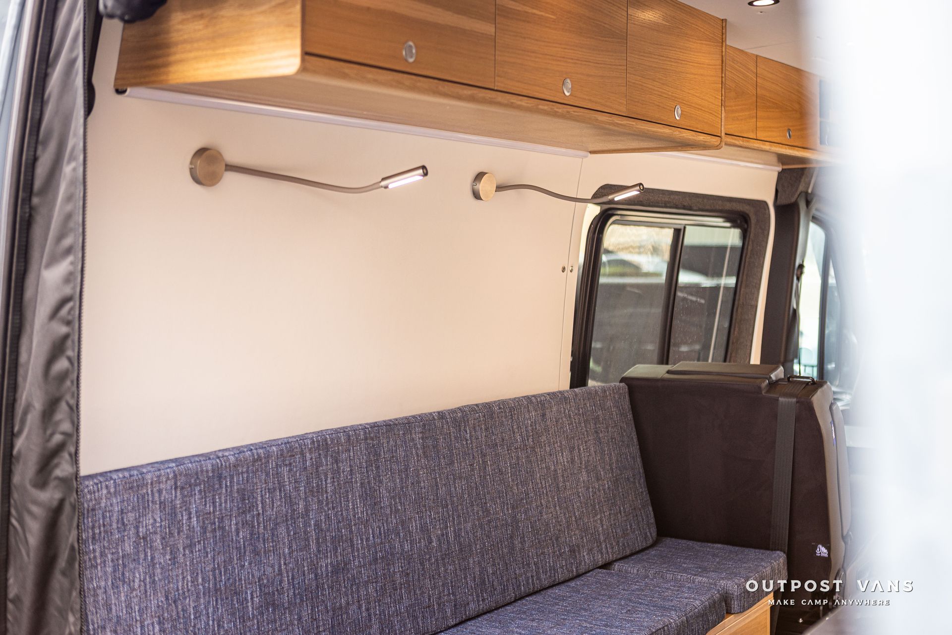 A couch is sitting in the back of a van.