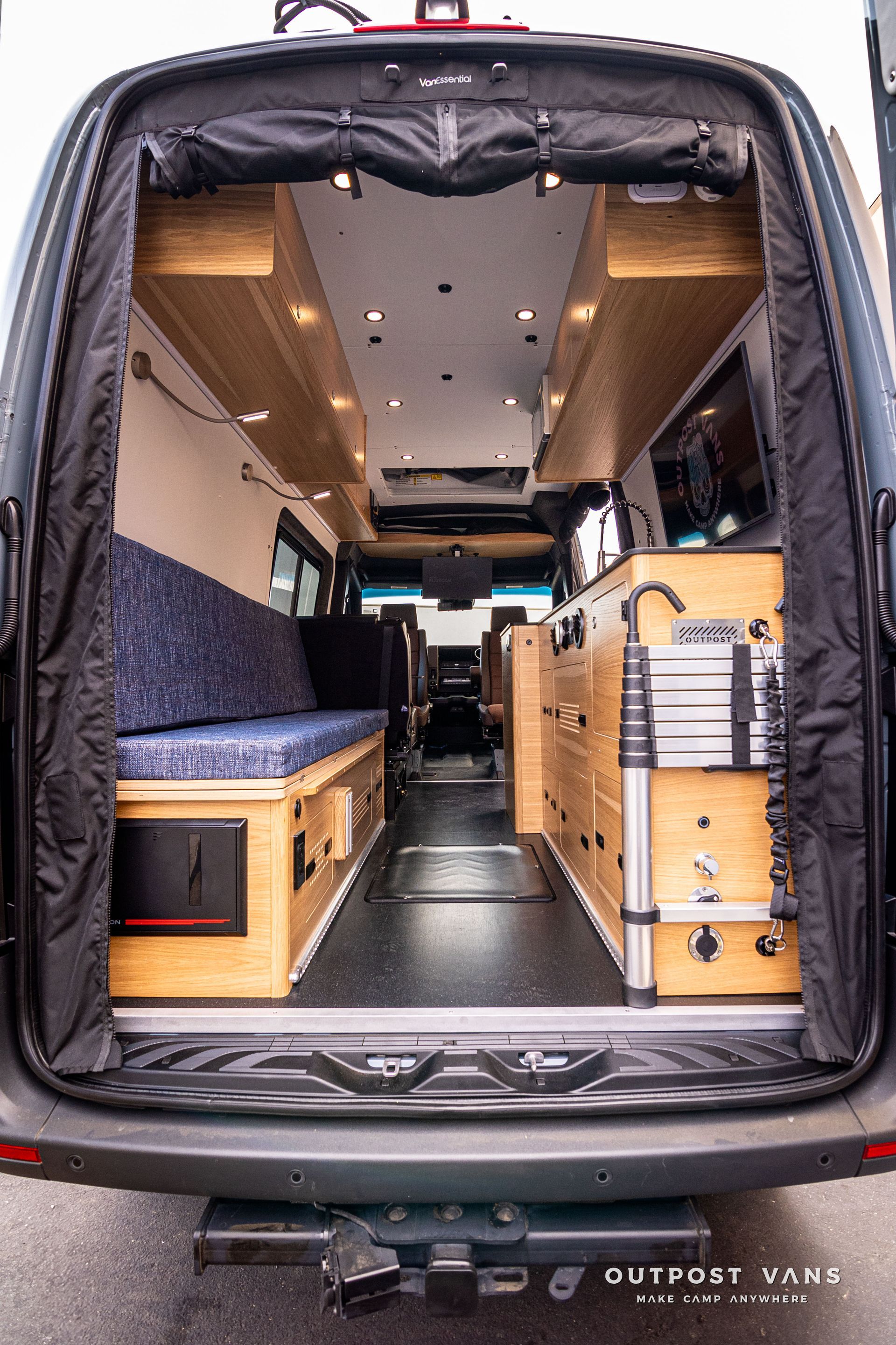 The back of a camper van with the door open.