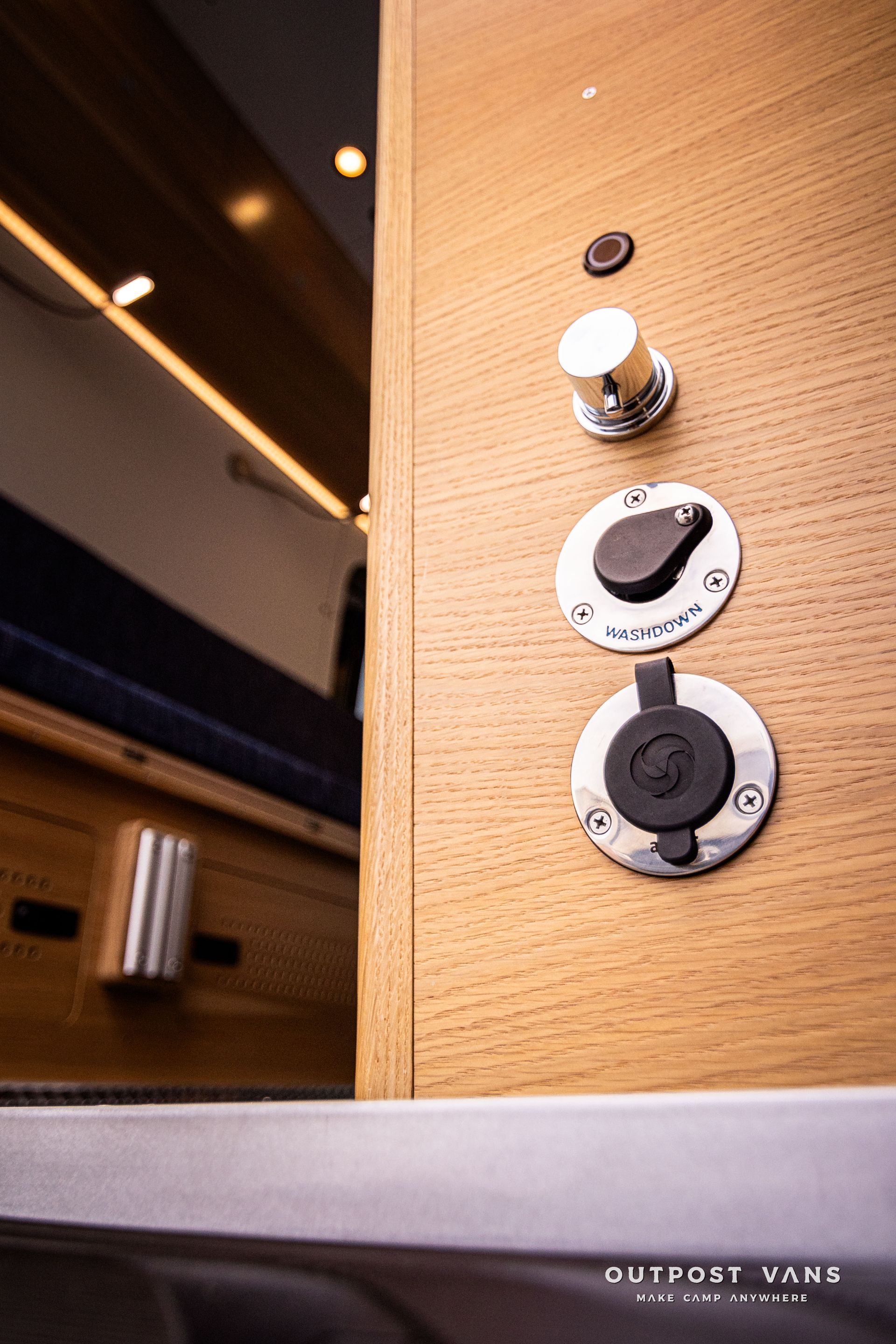A close up of a wooden door with a bunch of buttons on it.