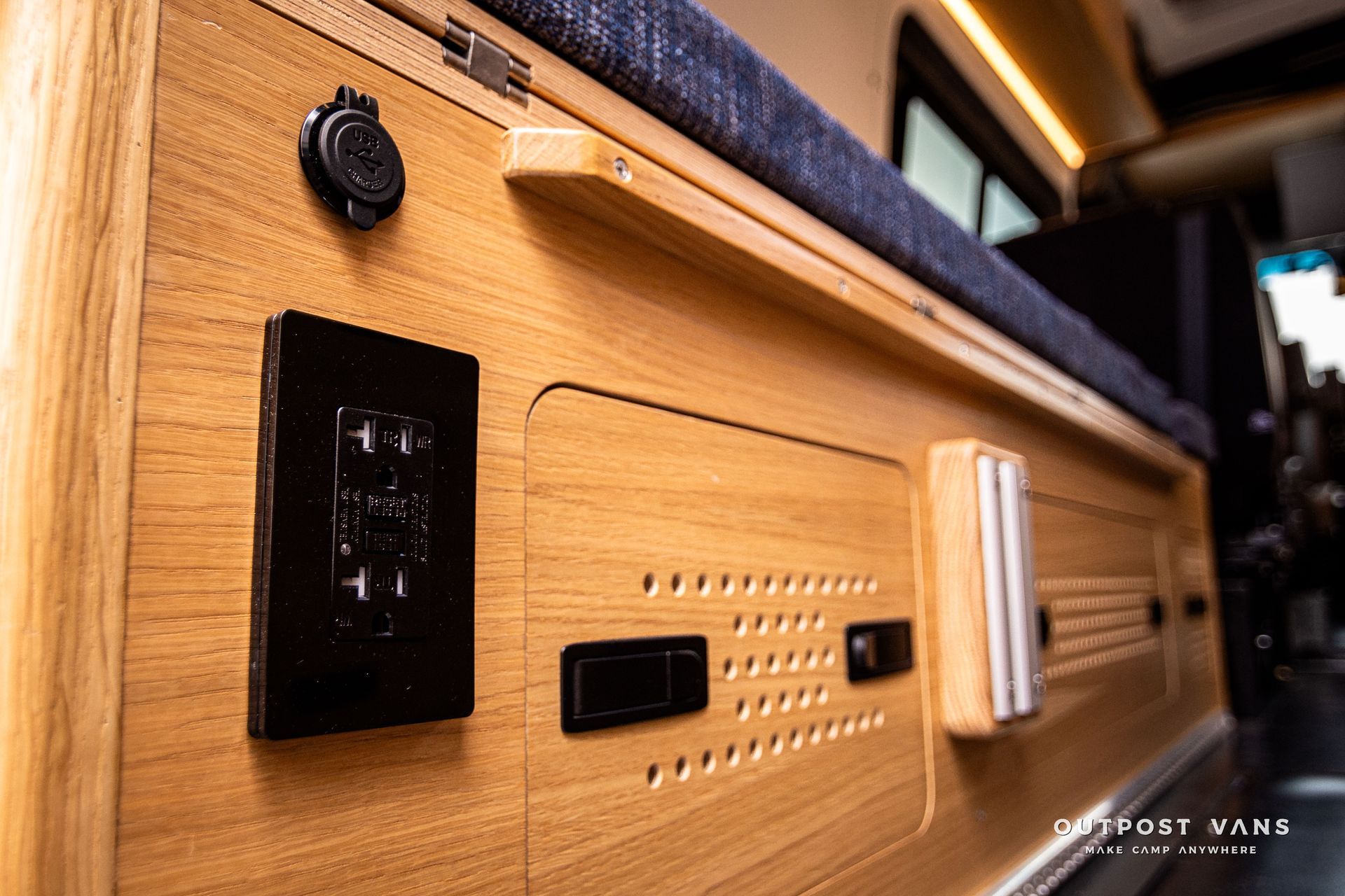 A close up of a wooden wall with electrical outlets.