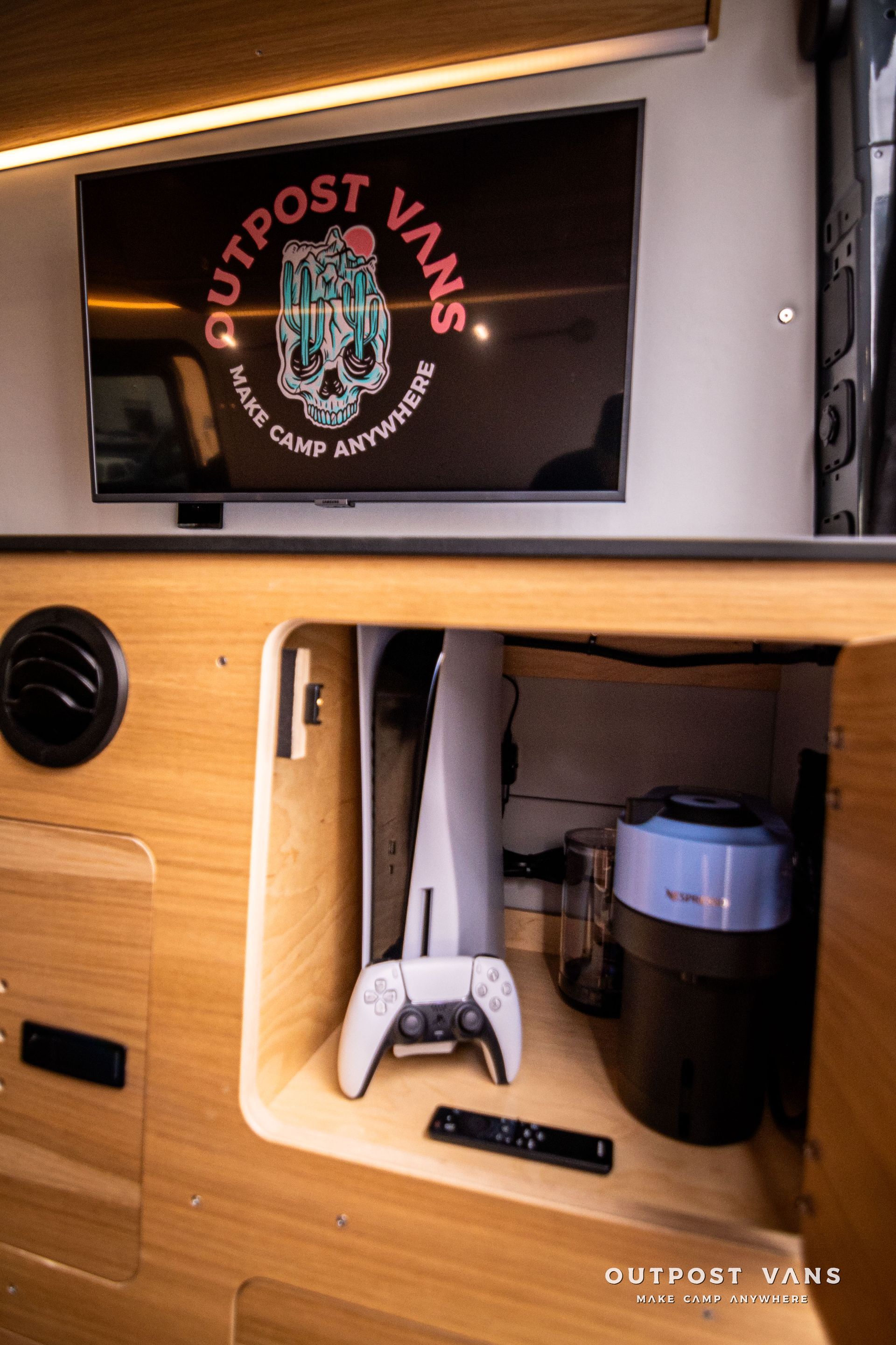 A playstation 5 is sitting in a corner of a van.