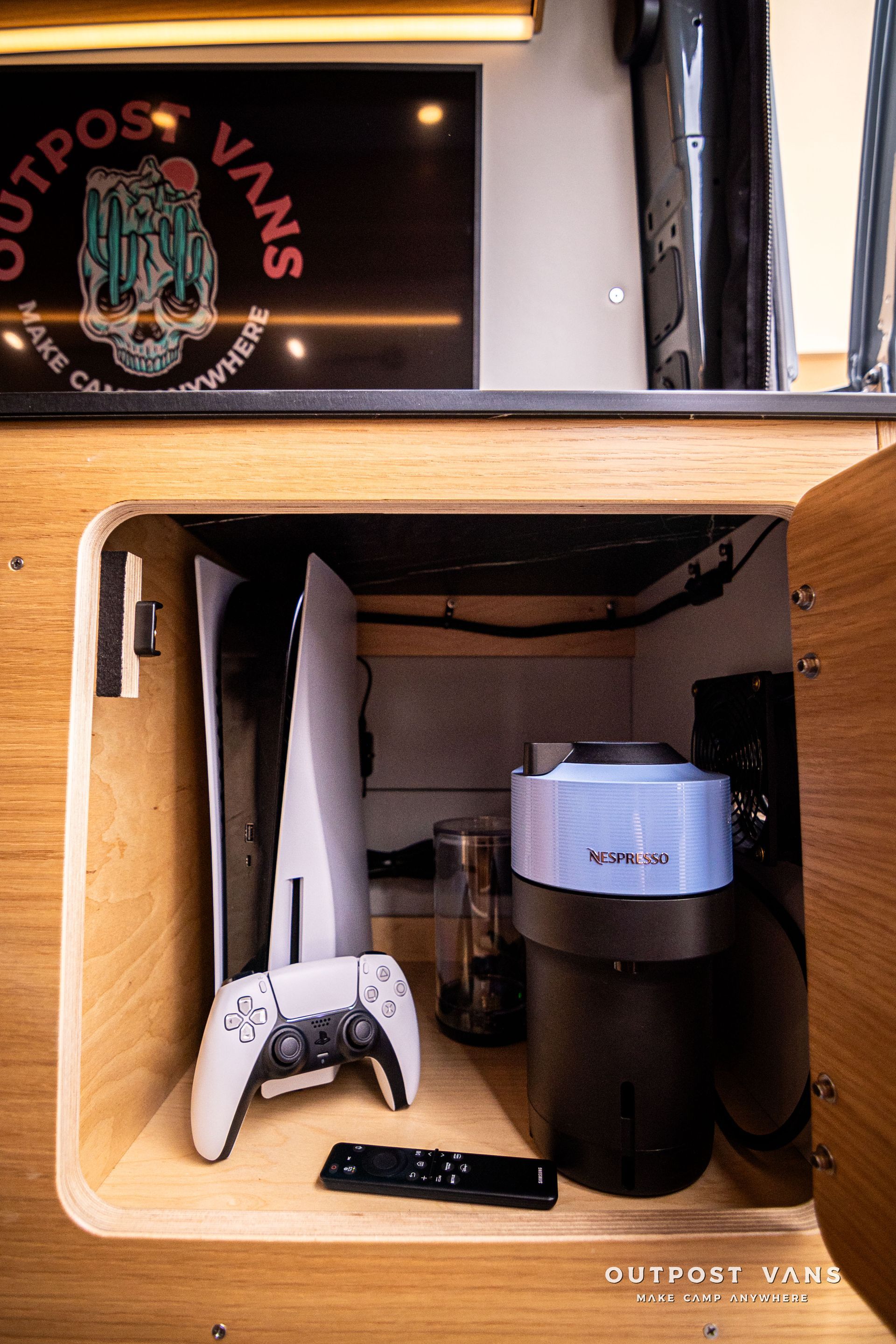 A video game controller is sitting in a wooden cabinet.