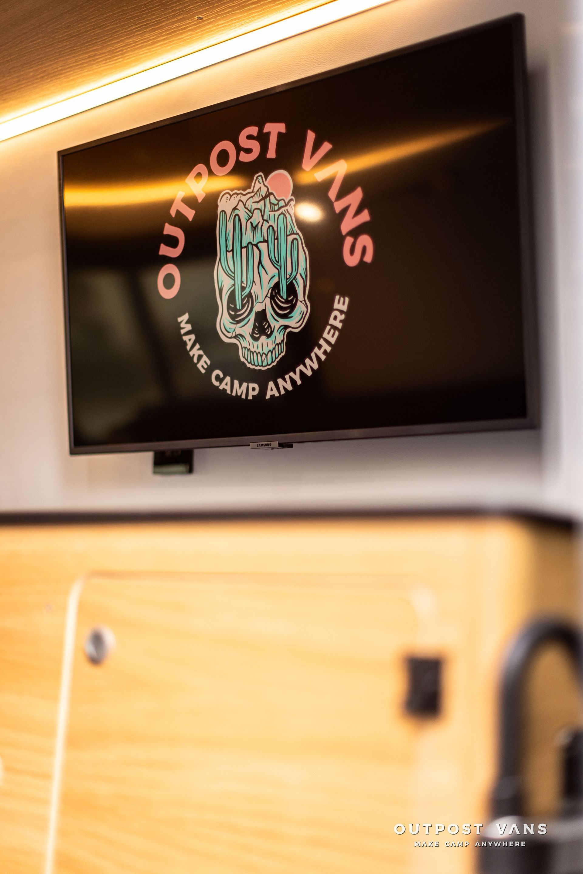 A flat screen tv is hanging on the wall in a room.