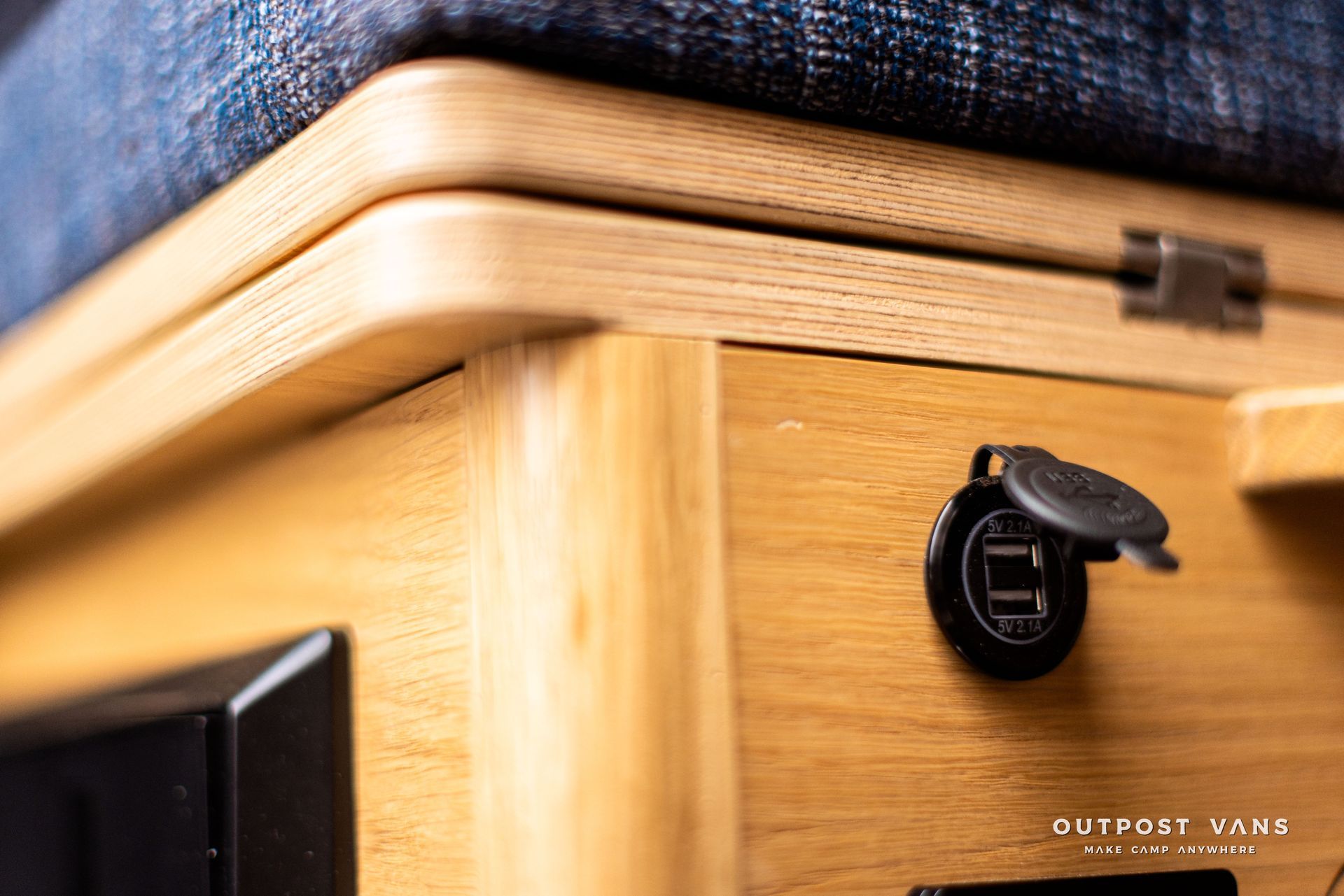 A close up of a wooden table with a charger on it.