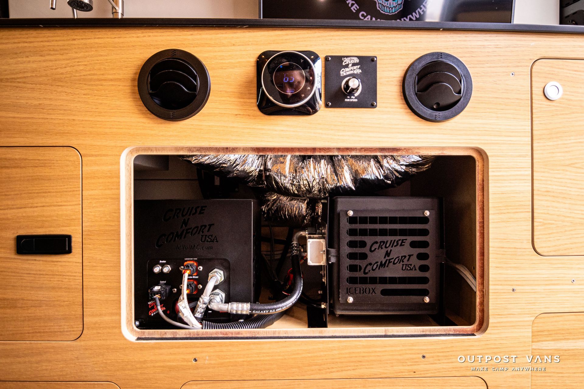 The inside of a wooden cabinet with the door open.