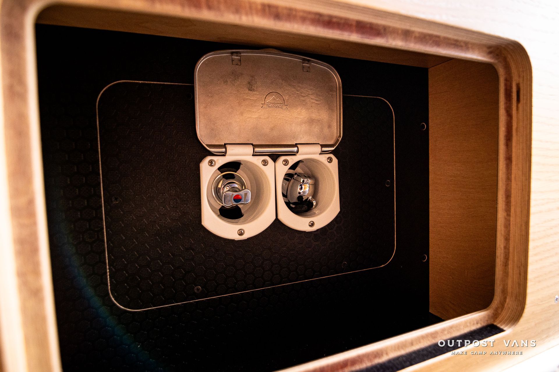 A wooden box with two light bulbs inside of it