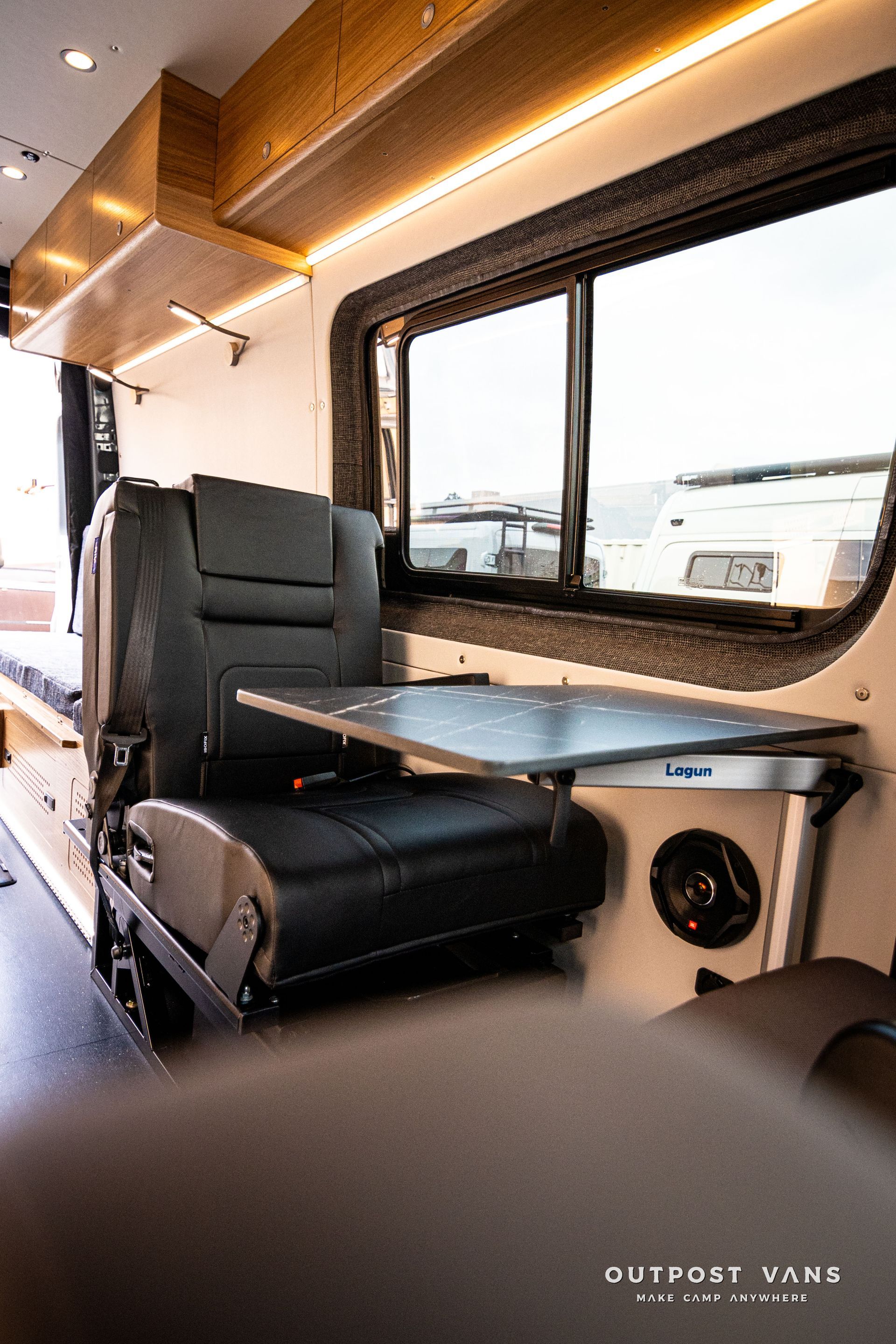 The inside of a van with a table and chairs.