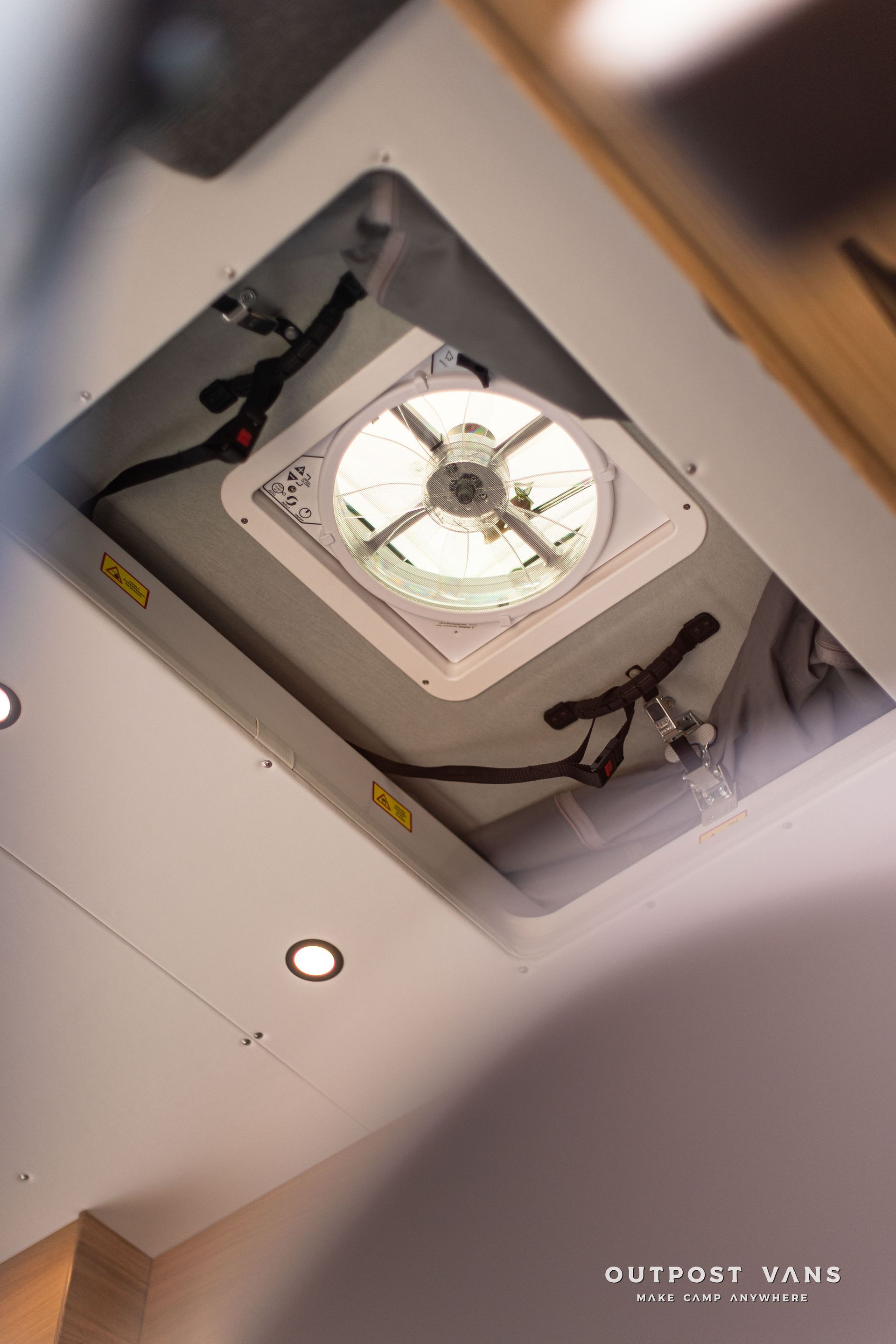 A fan is hanging from the ceiling of a room.