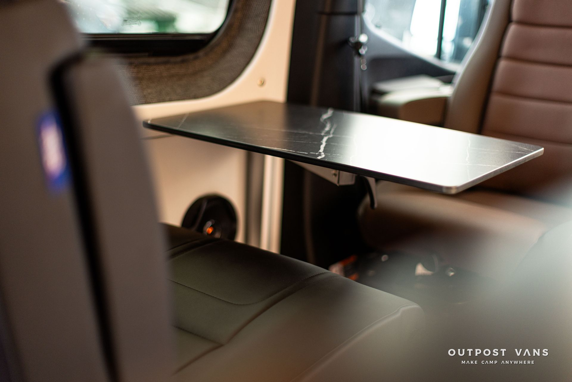 A table is sitting on the back seat of a van.