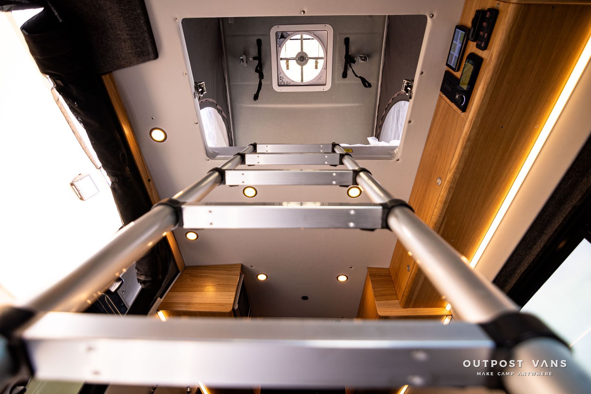 A ladder is going up to the ceiling of a van.