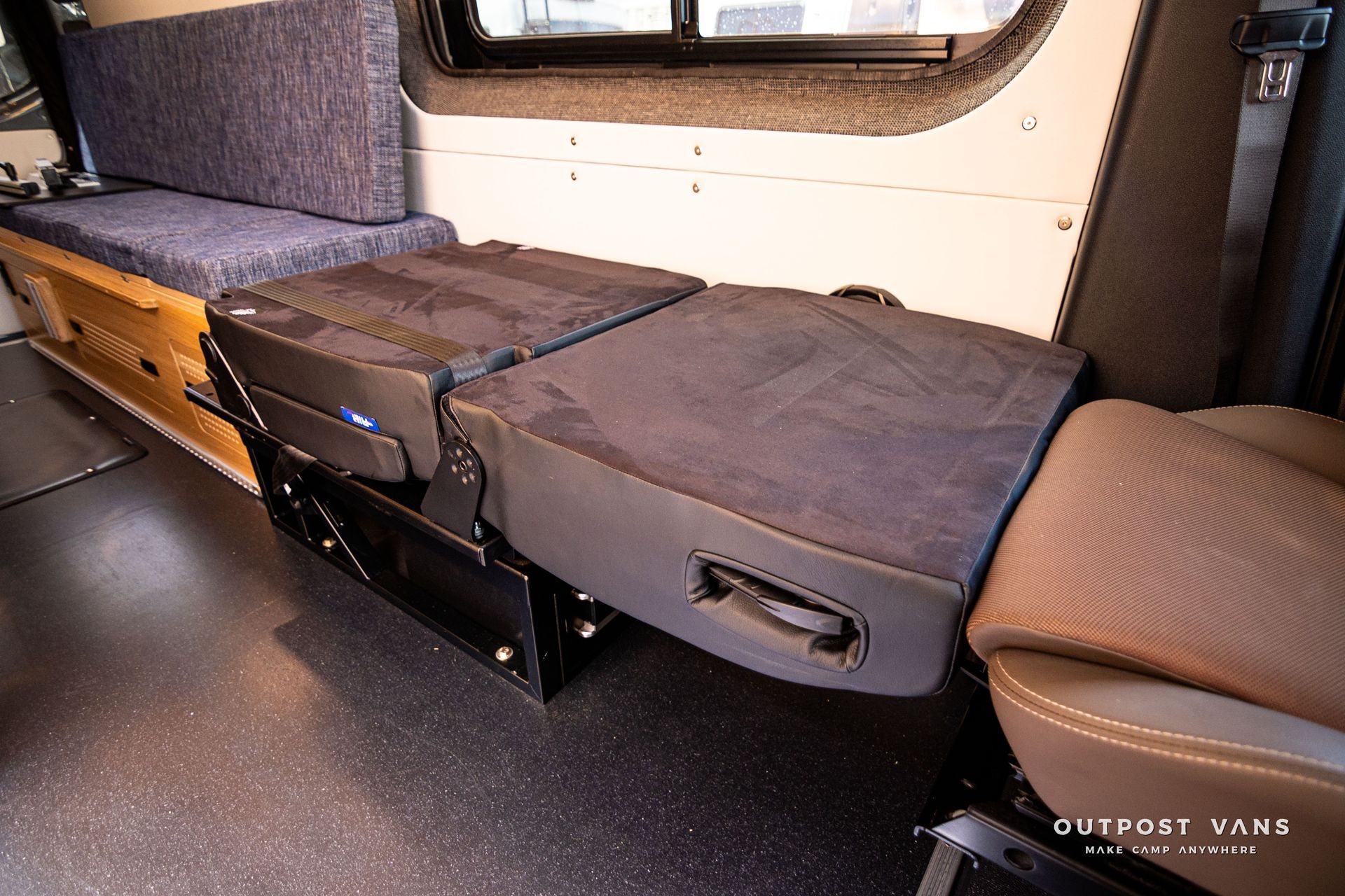 A van with two seats folded down and a window.