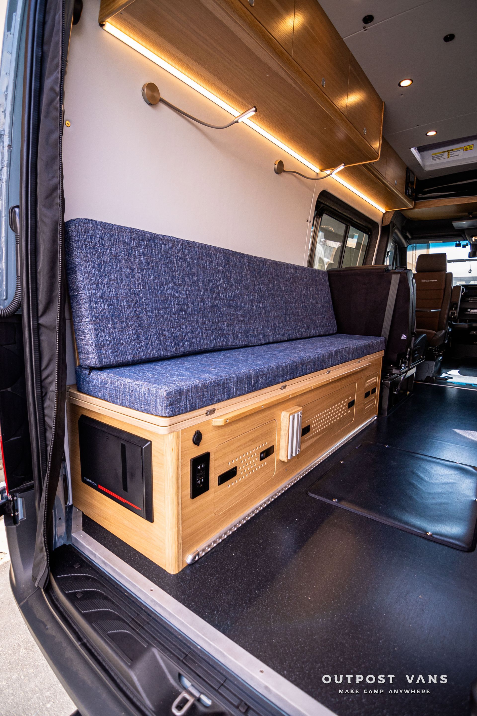 A couch is sitting in the back of a van.