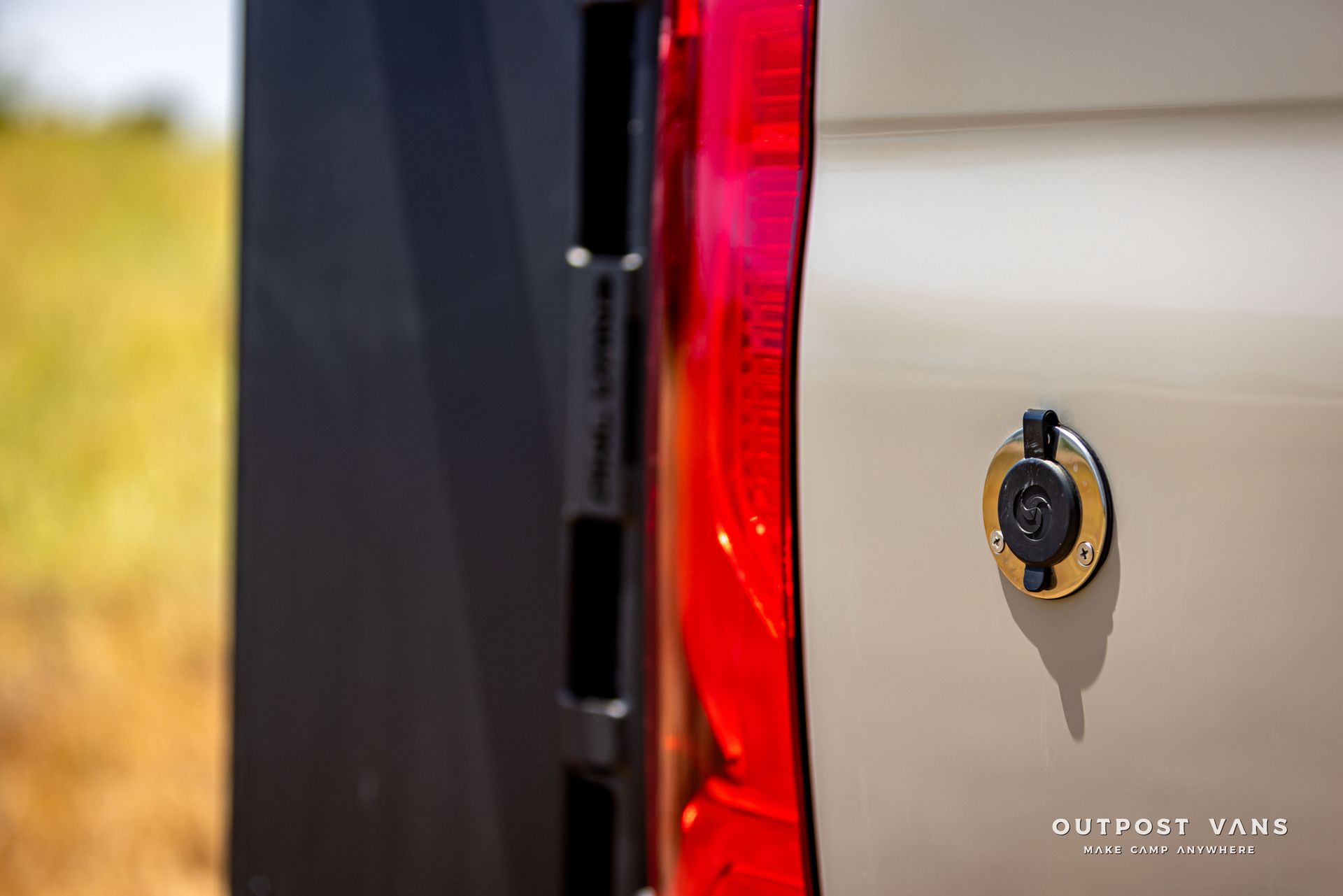 A close up of the back of a truck with a red tail light.