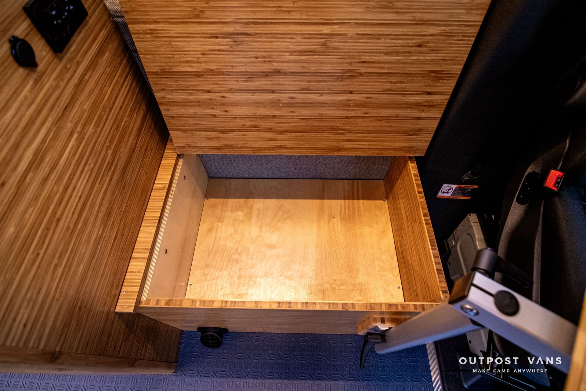 A wooden box is sitting on the floor in a room.