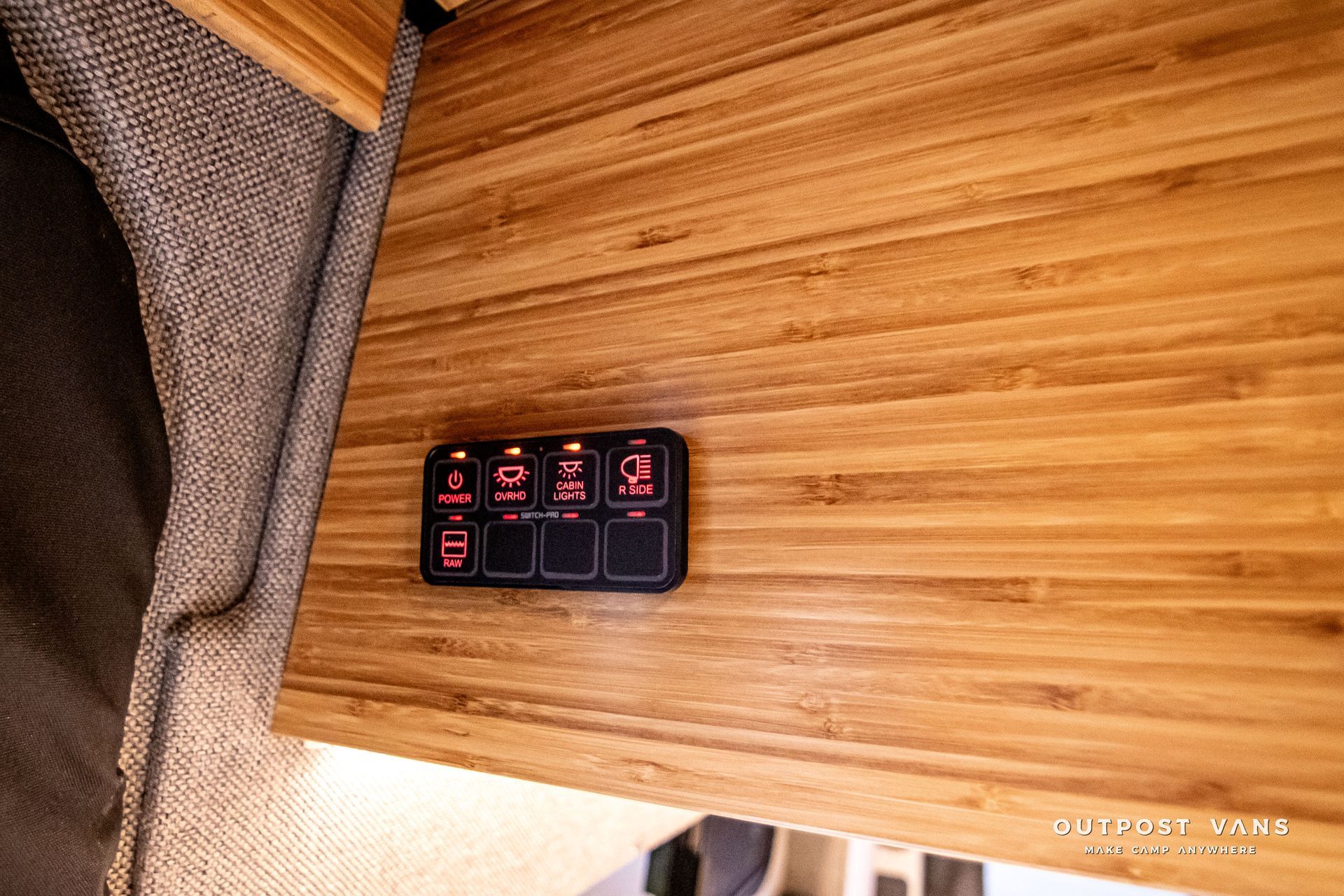A wooden counter top with a remote control on it.