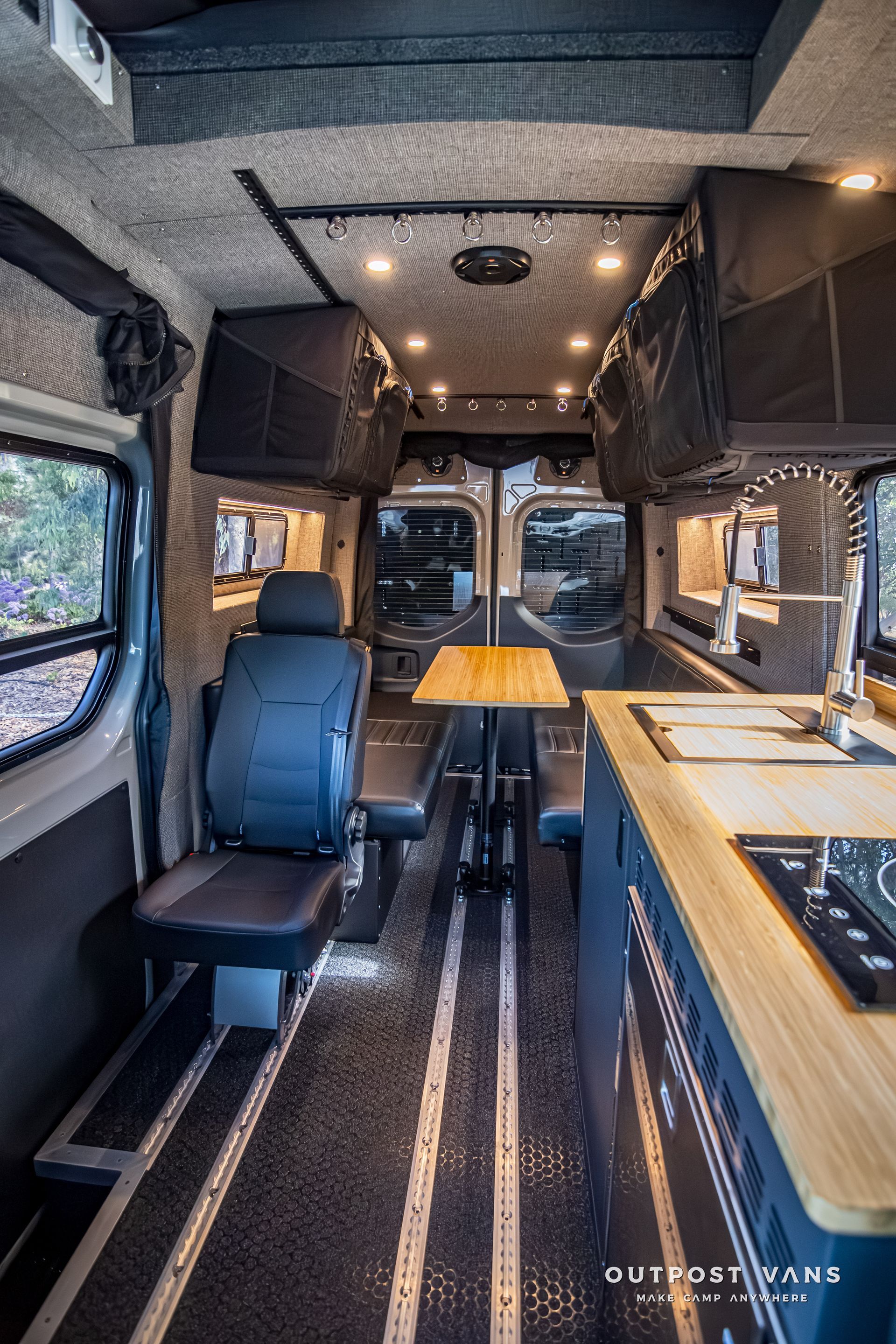 The inside of a van with a table and chairs.