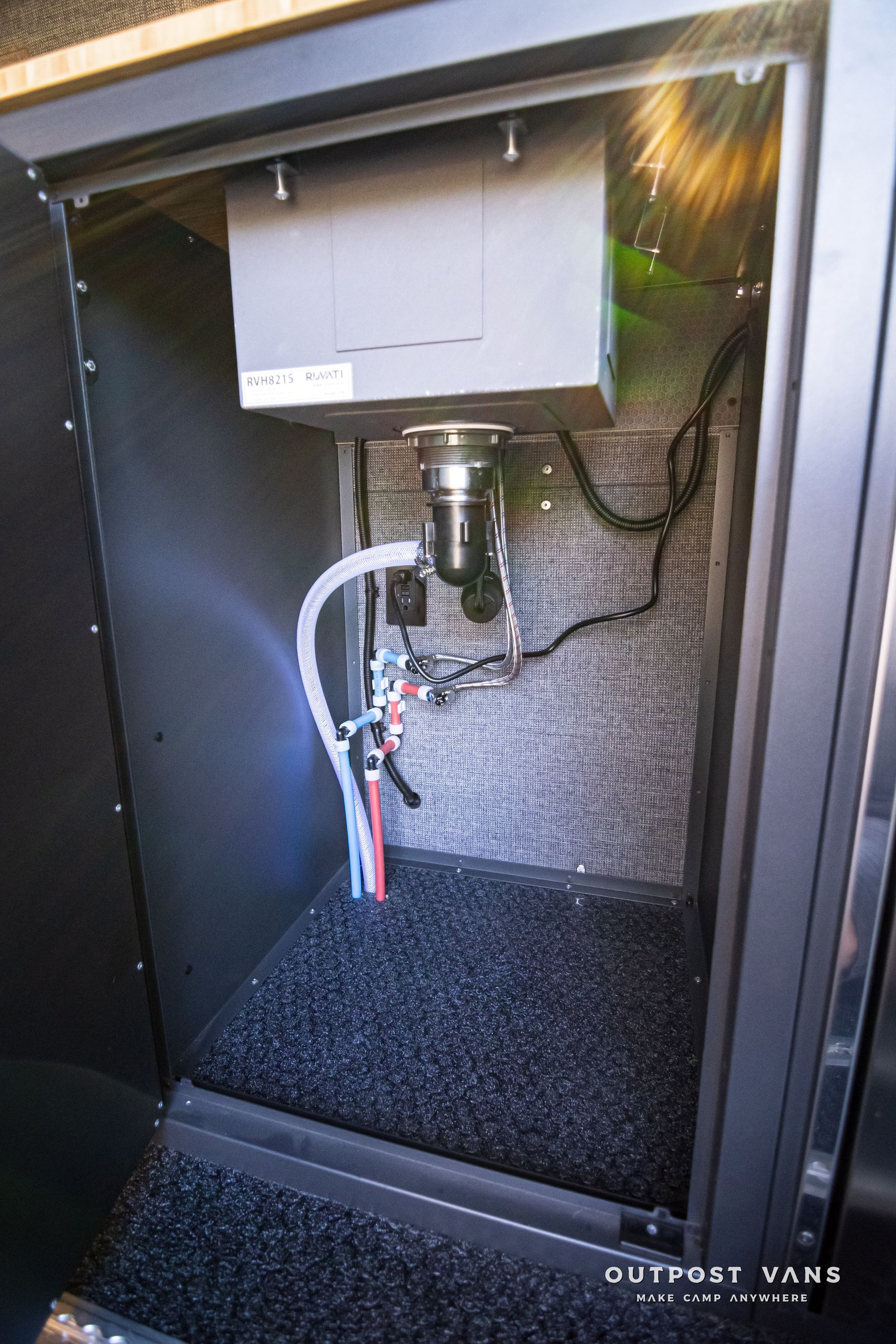 A black cabinet with a sink inside of it.