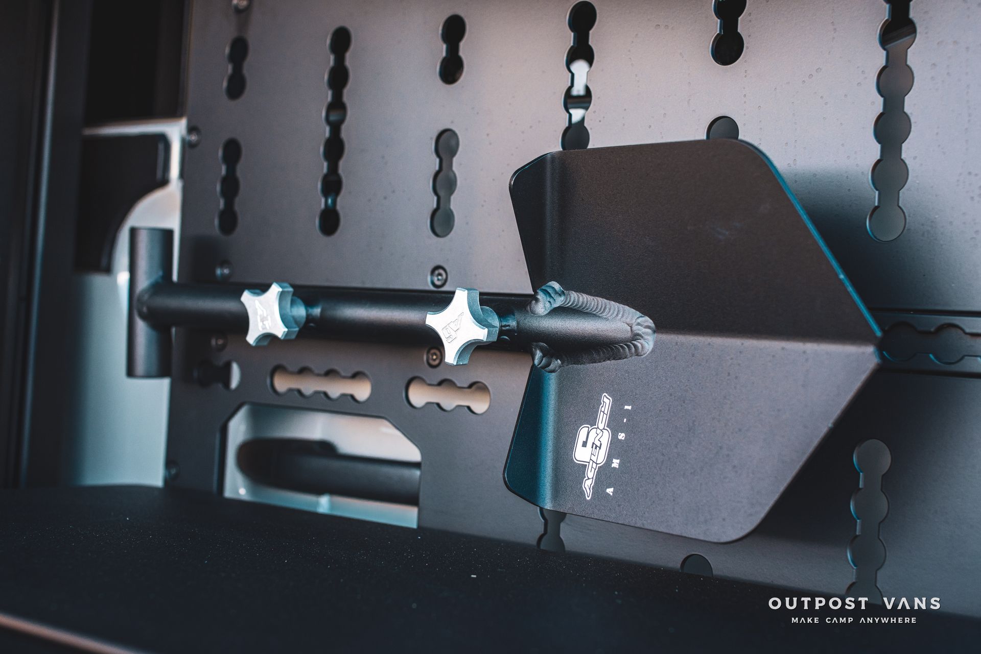 The word outpost that is on a piece of metal