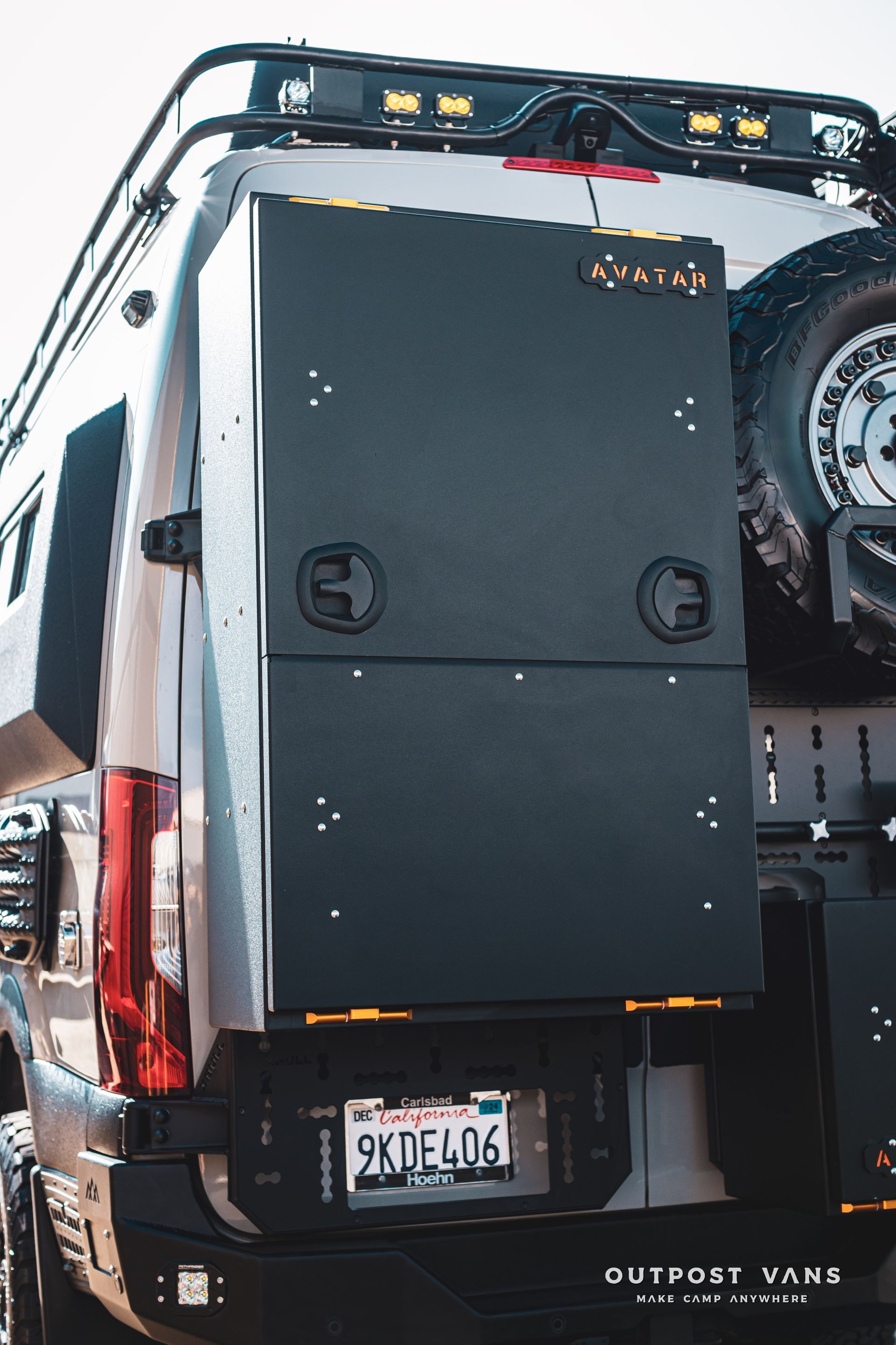 A white van with a black box on the back of it.