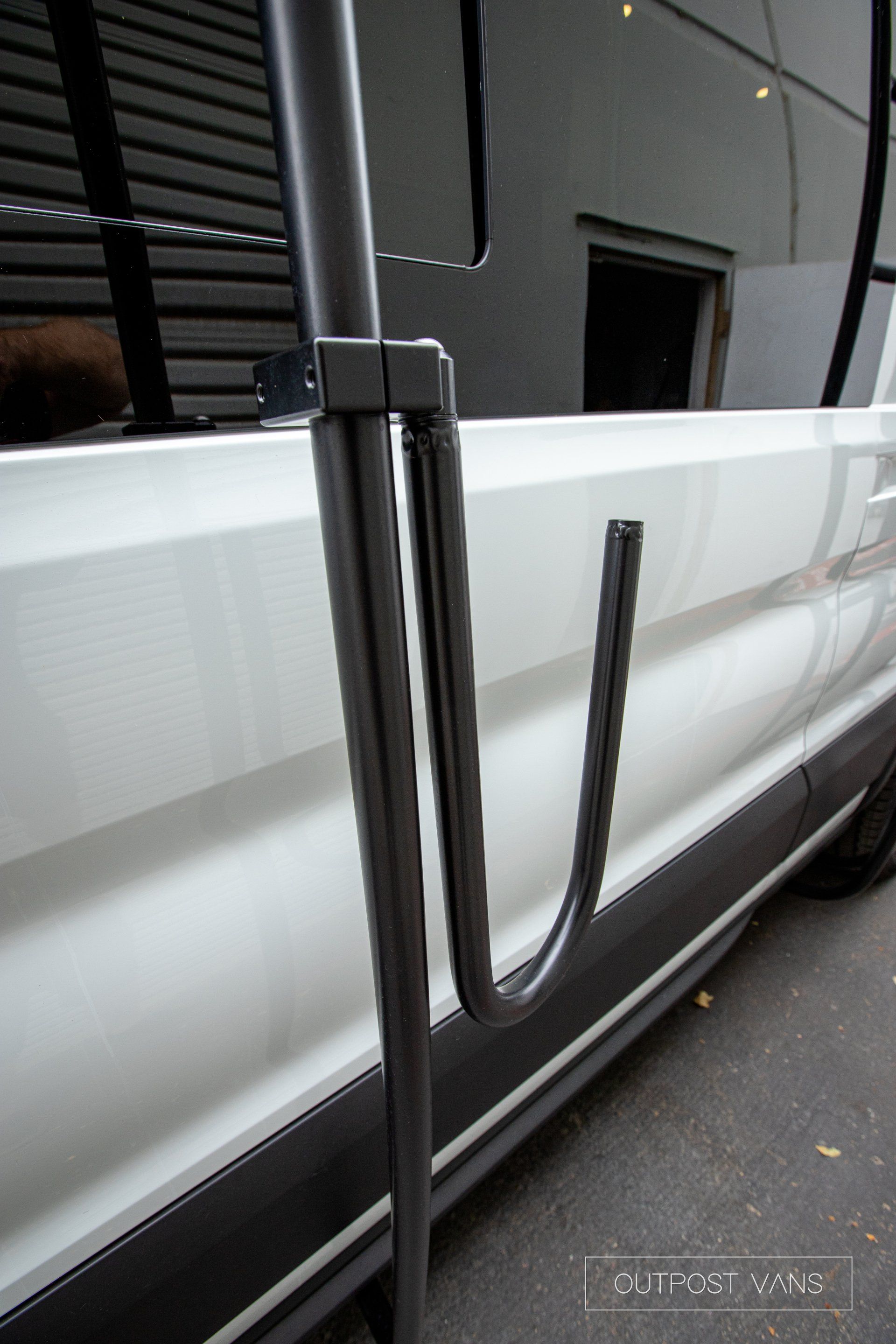 a white van with a surfboard rack attached to the side