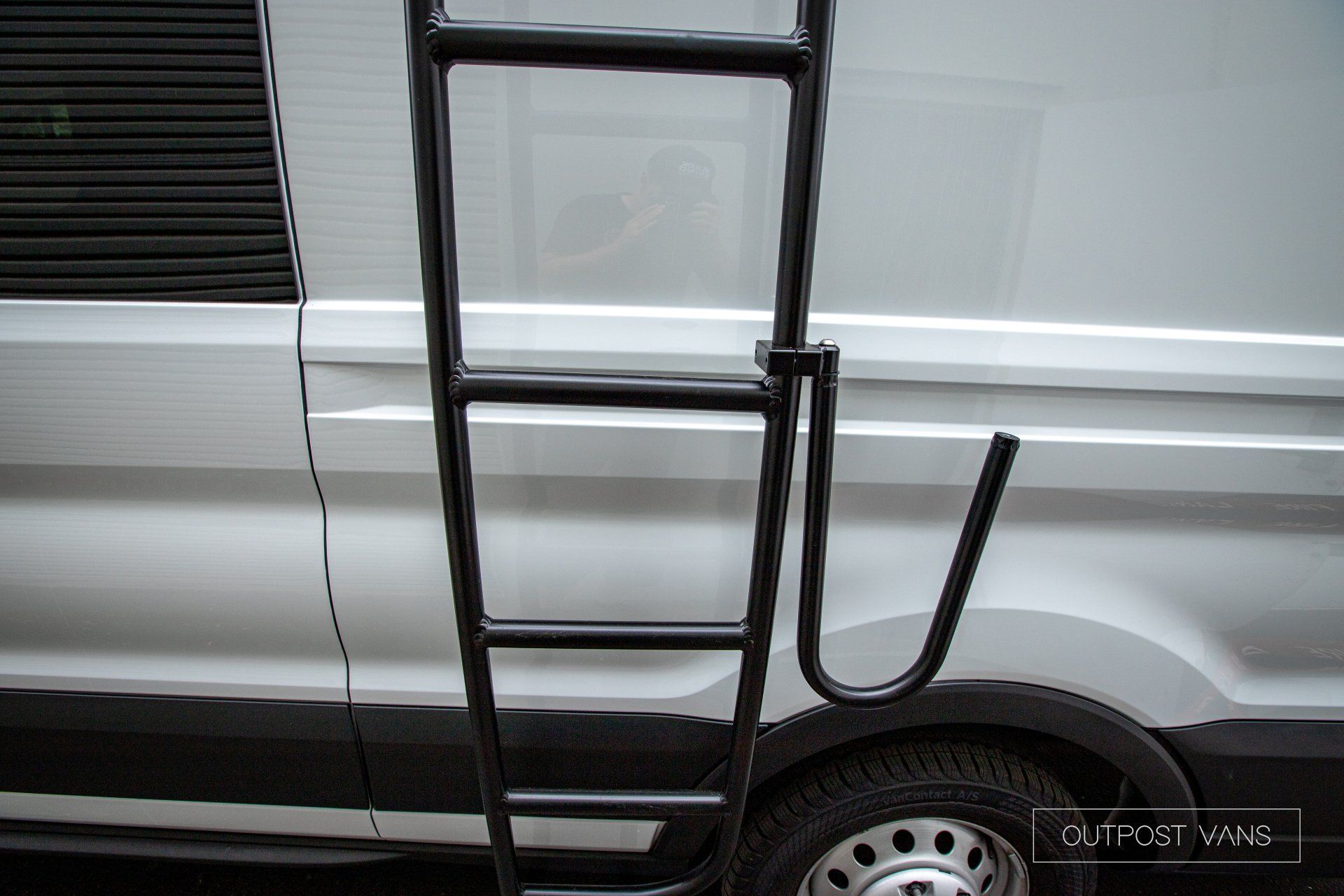 a ladder is attached to the side of a van .
