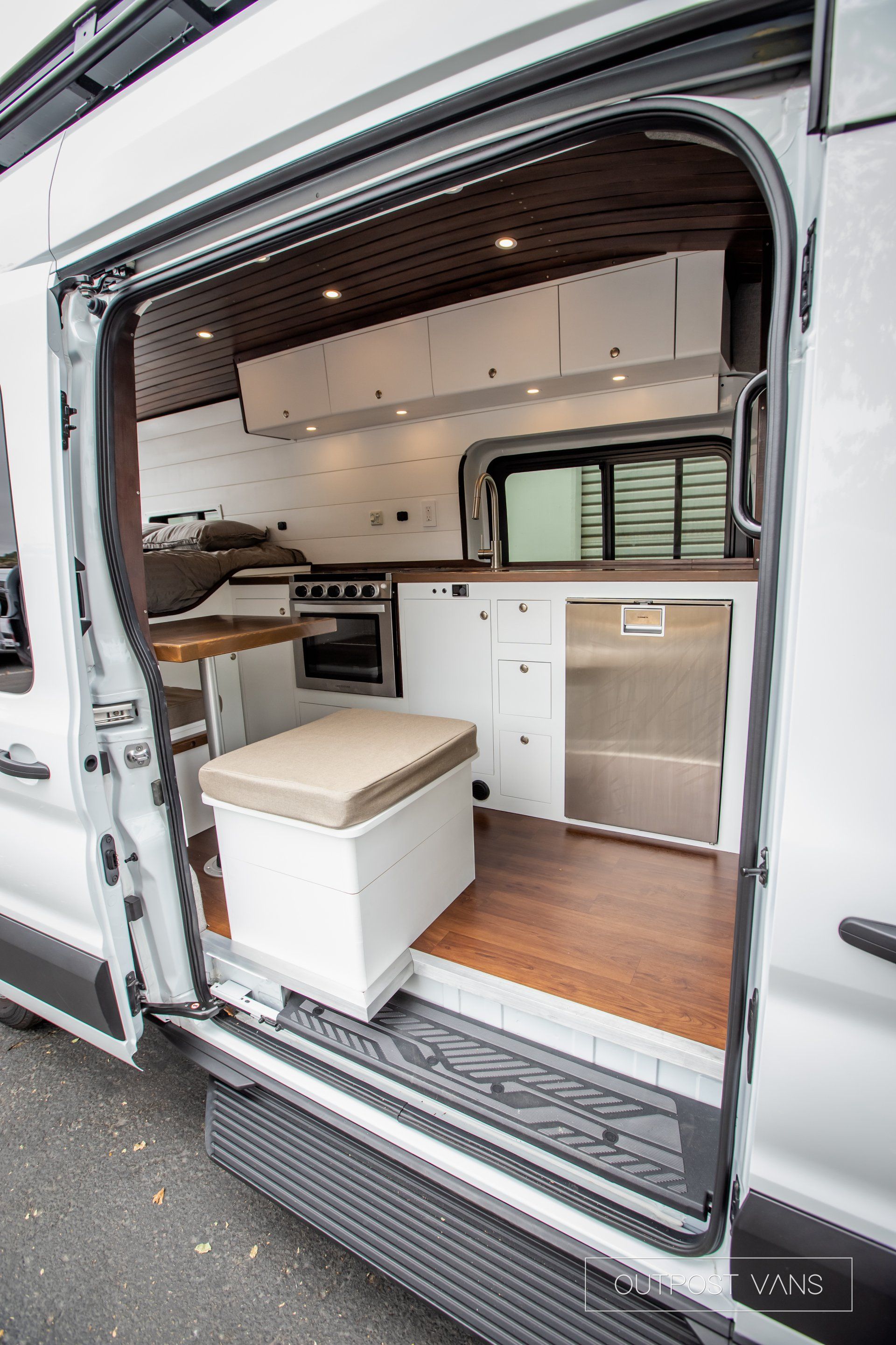 a white van with the door open and a stool in the back .