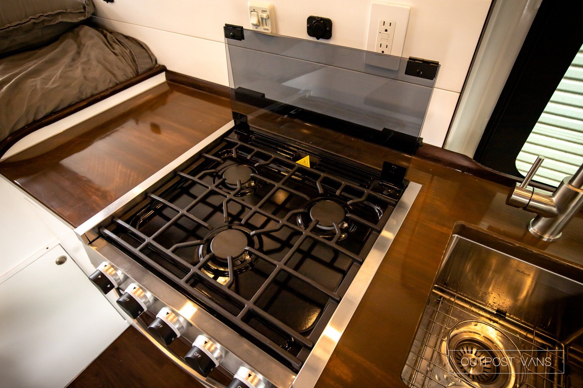 a stove top oven is sitting on top of a wooden counter in a kitchen .