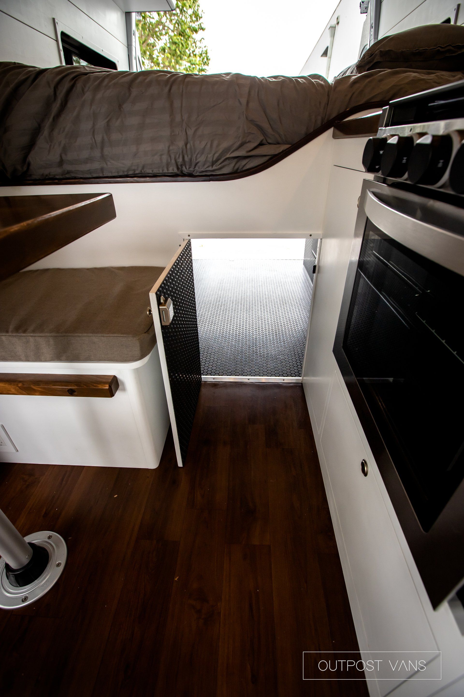 the inside of a camper van with a bed and a stove .