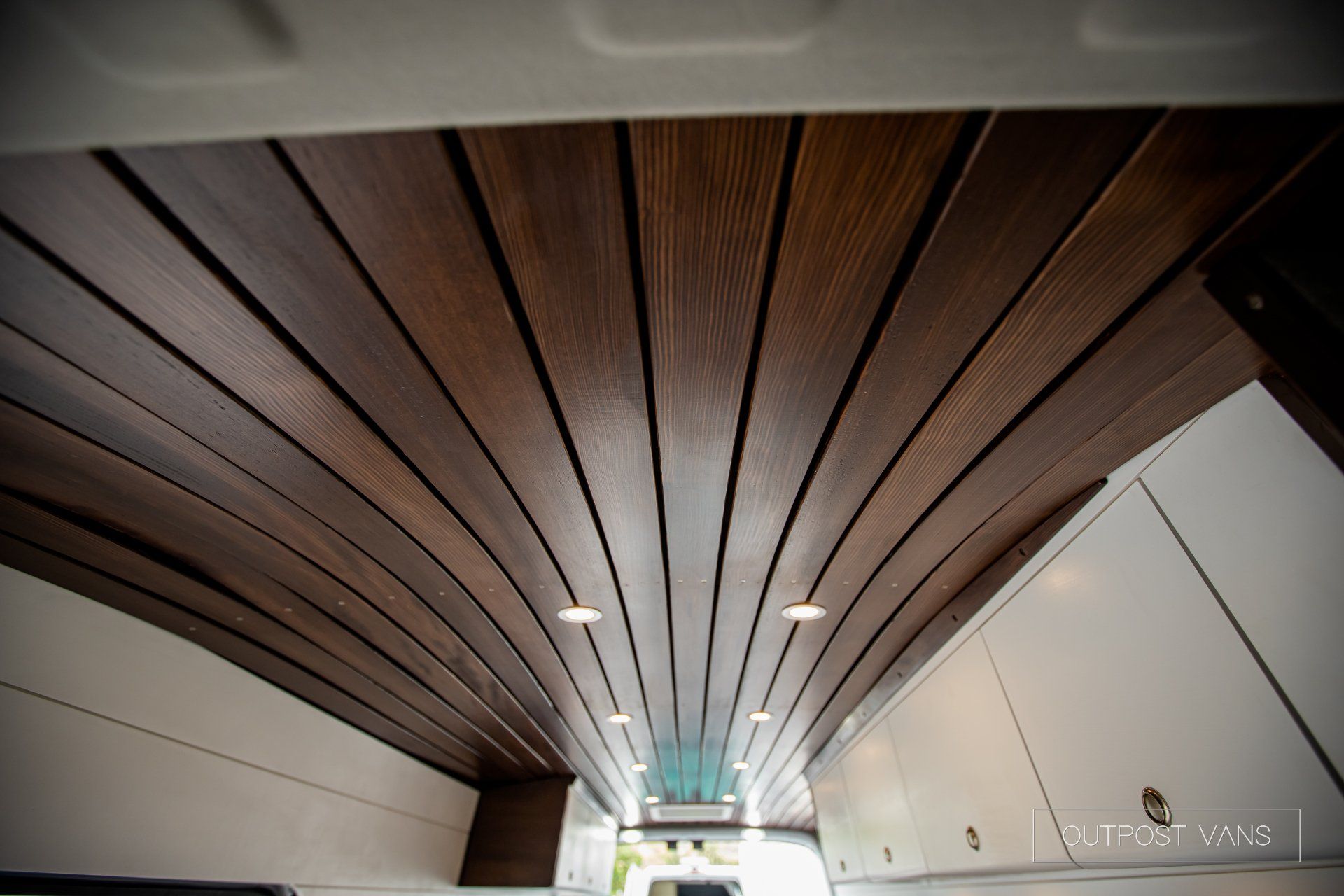 a kitchen with a wooden ceiling and white cabinets