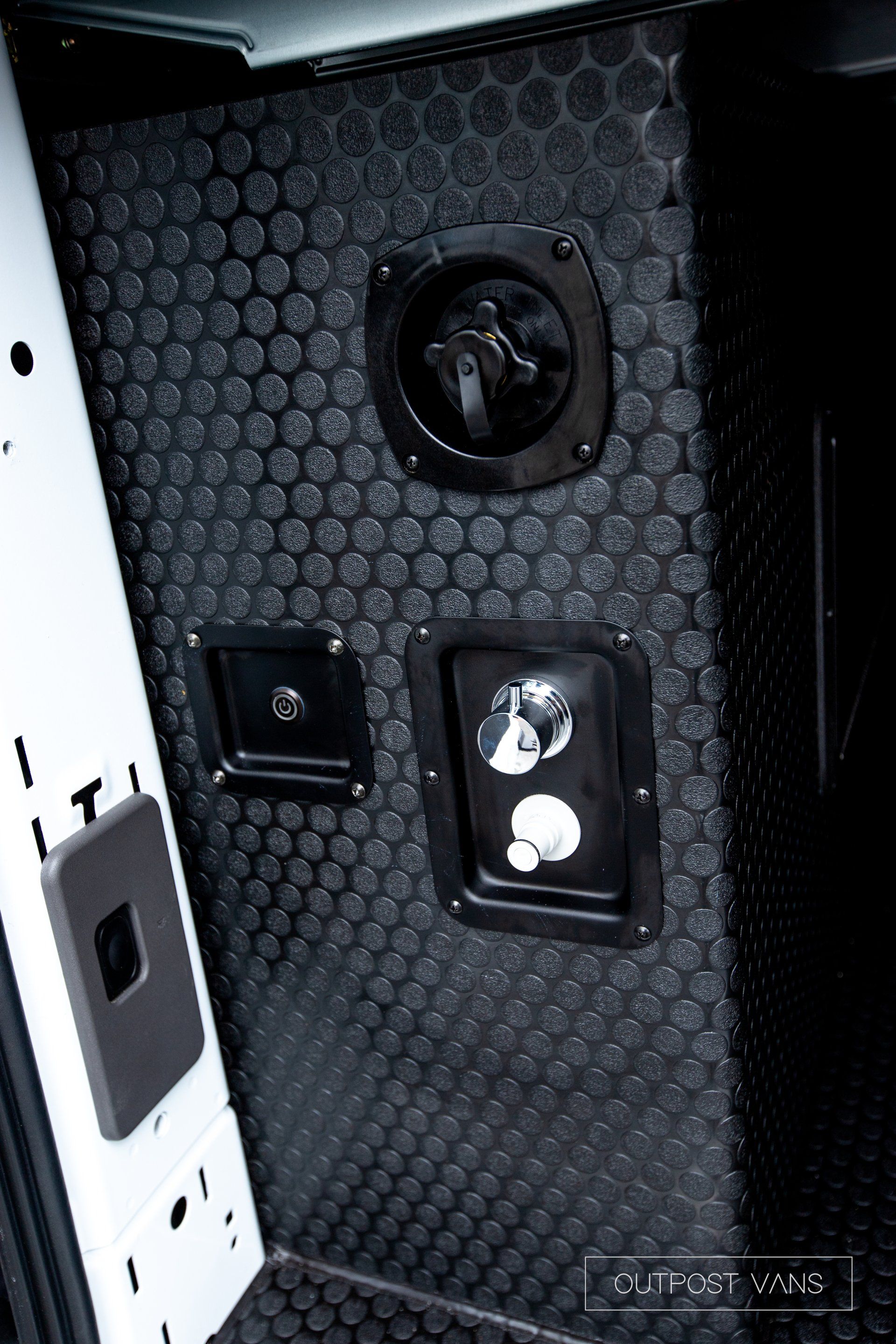 a close up of a black and white wall with electrical outlets .